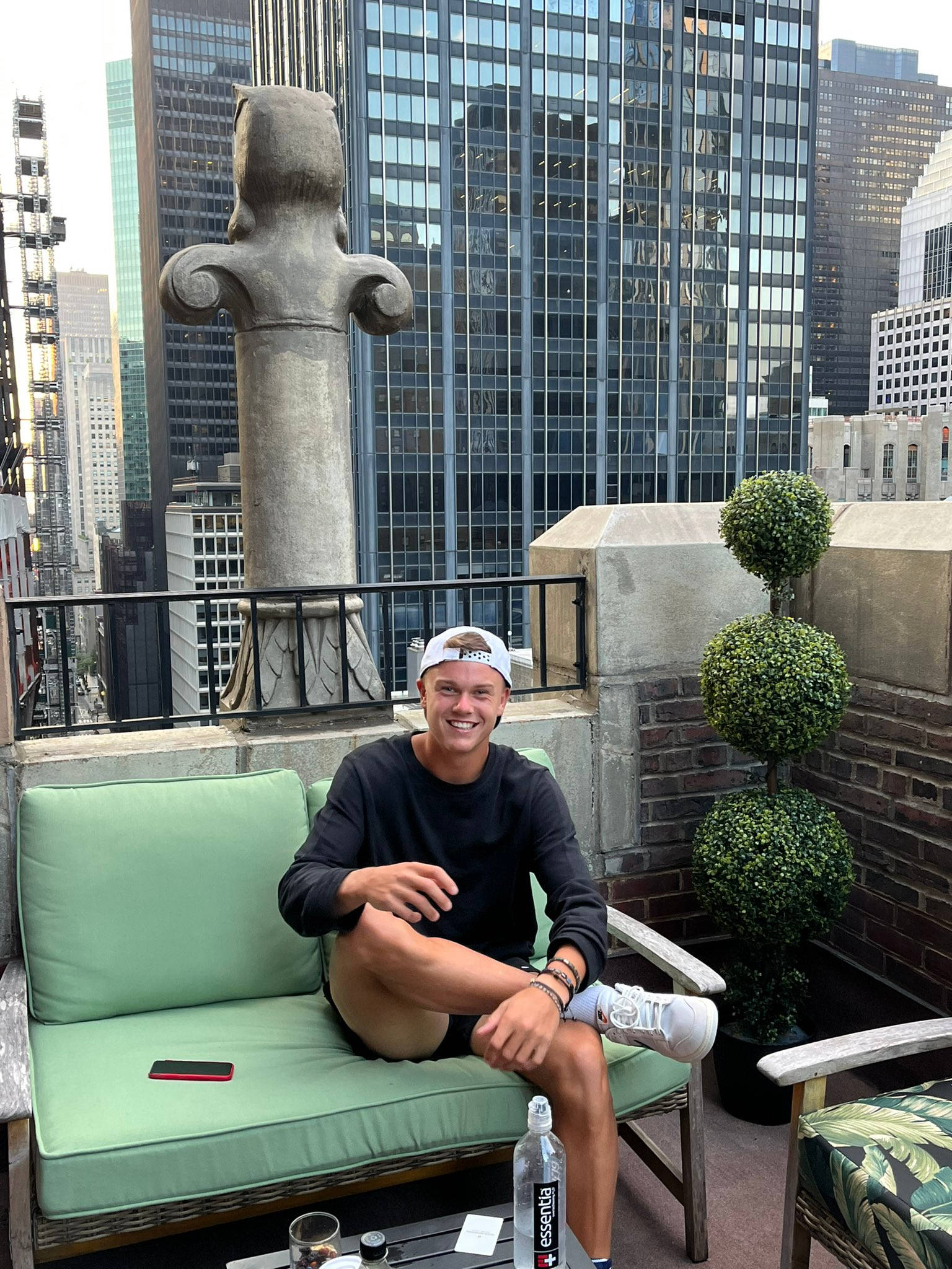 Holger Rune, green rooftop couch, city skyscrapers, Full HD Phone Wallpaper