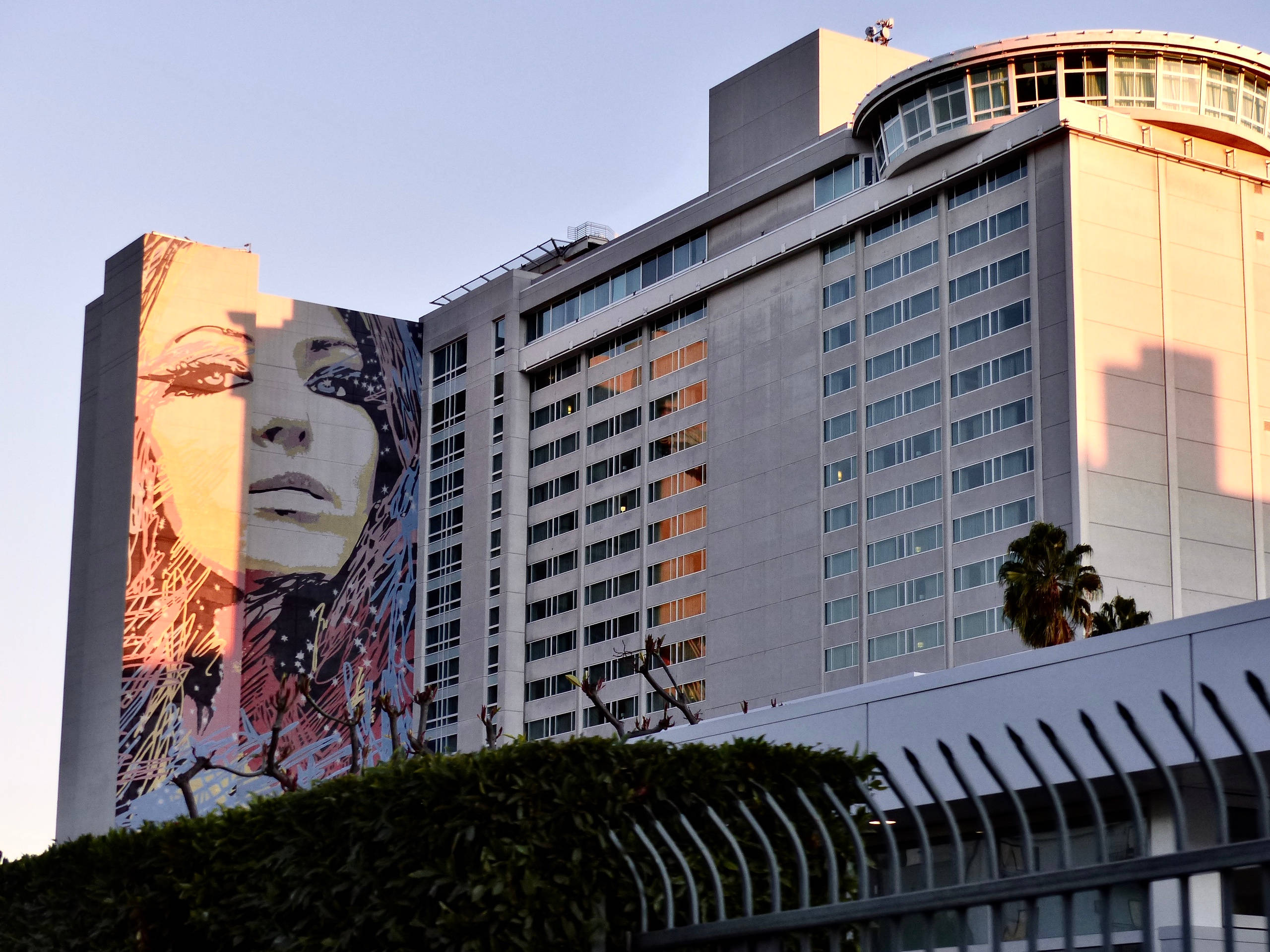 Hollywood Street, towering hotel building, massive colorful mural, 2K Desktop Wallpaper