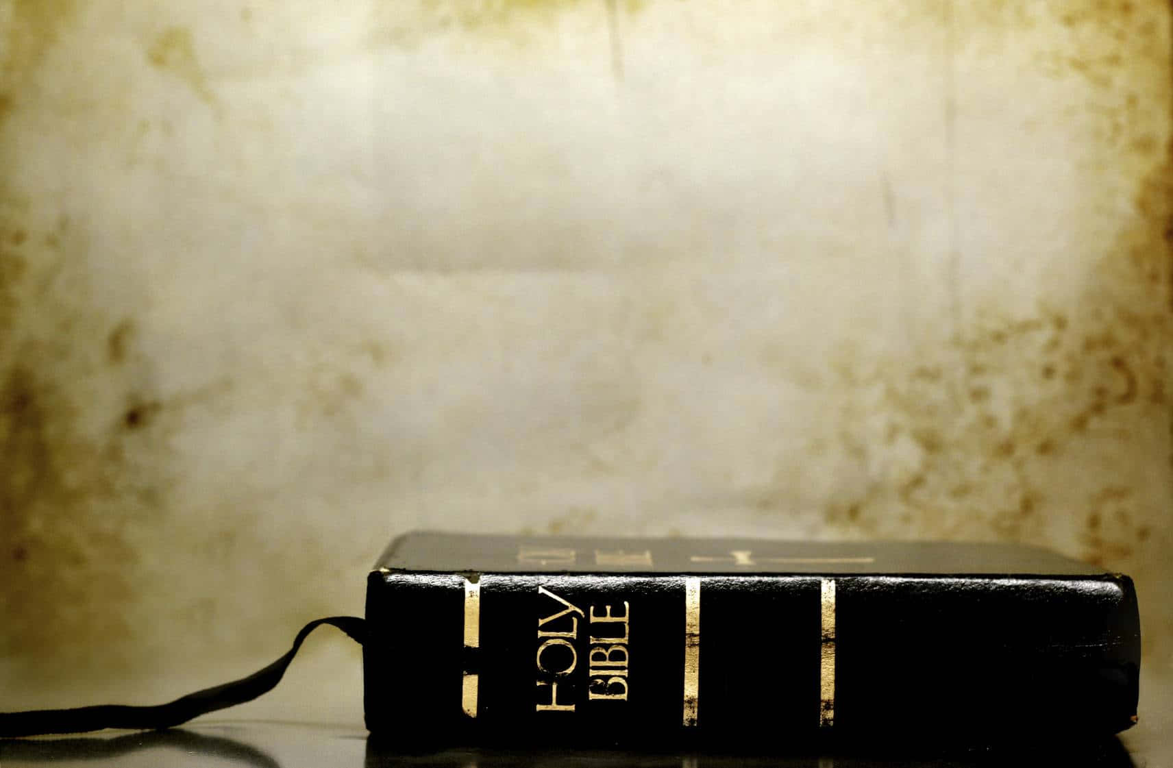 Holy Bible, black leather-bound, reflective surface, HD Desktop Wallpaper