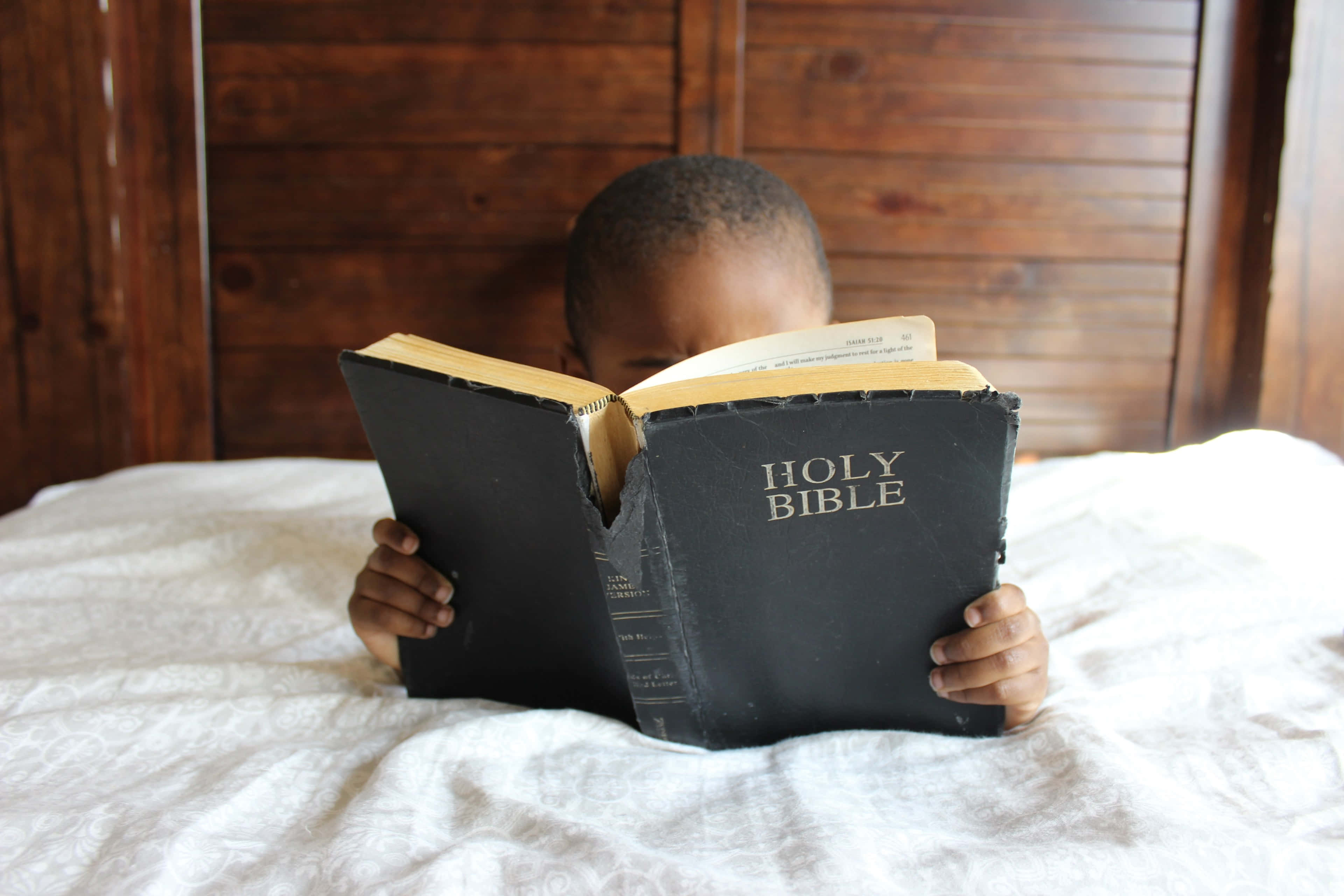 Holy Bible, young child, white bedspread, 4K Desktop Wallpaper