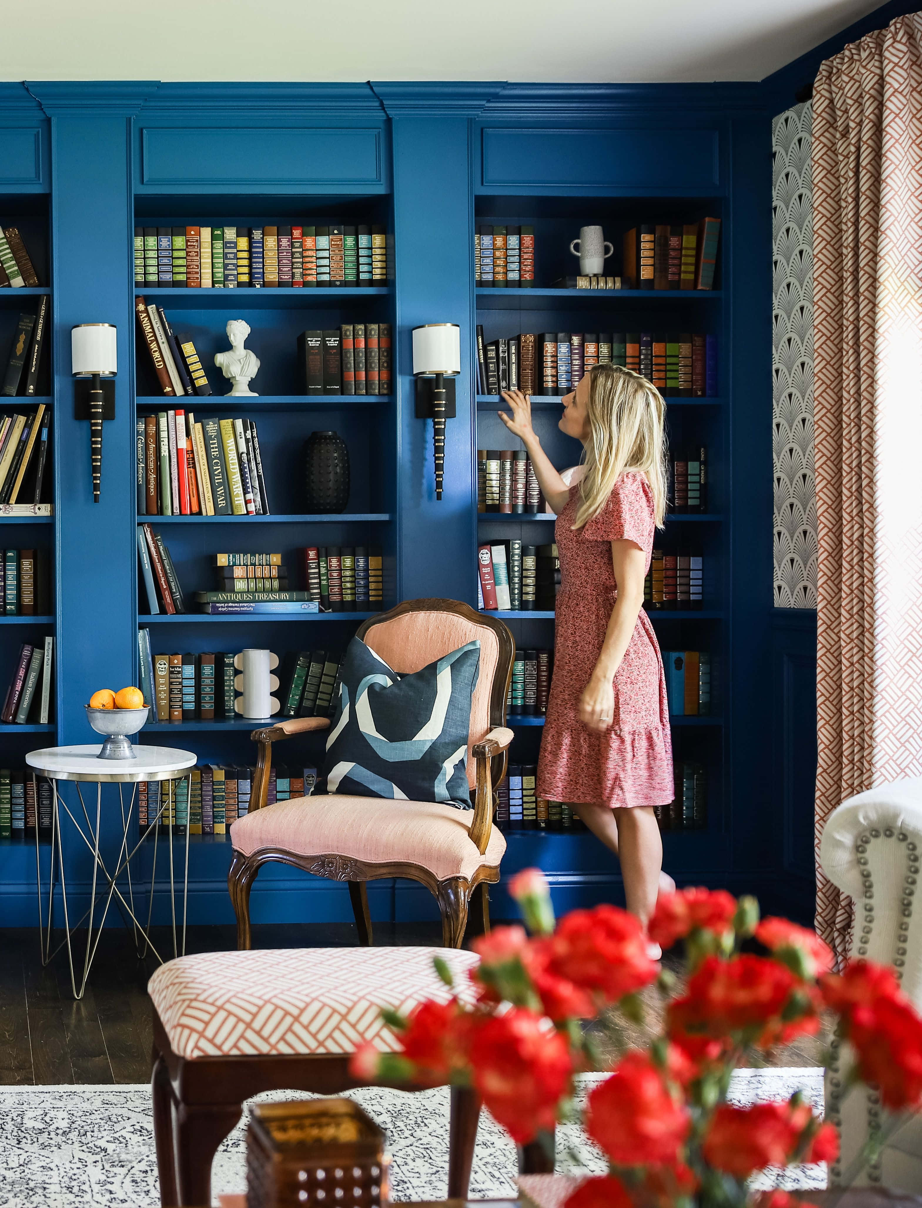 Home Library, pink dress, vibrant blue built-in bookshelf, 4K Phone Wallpaper