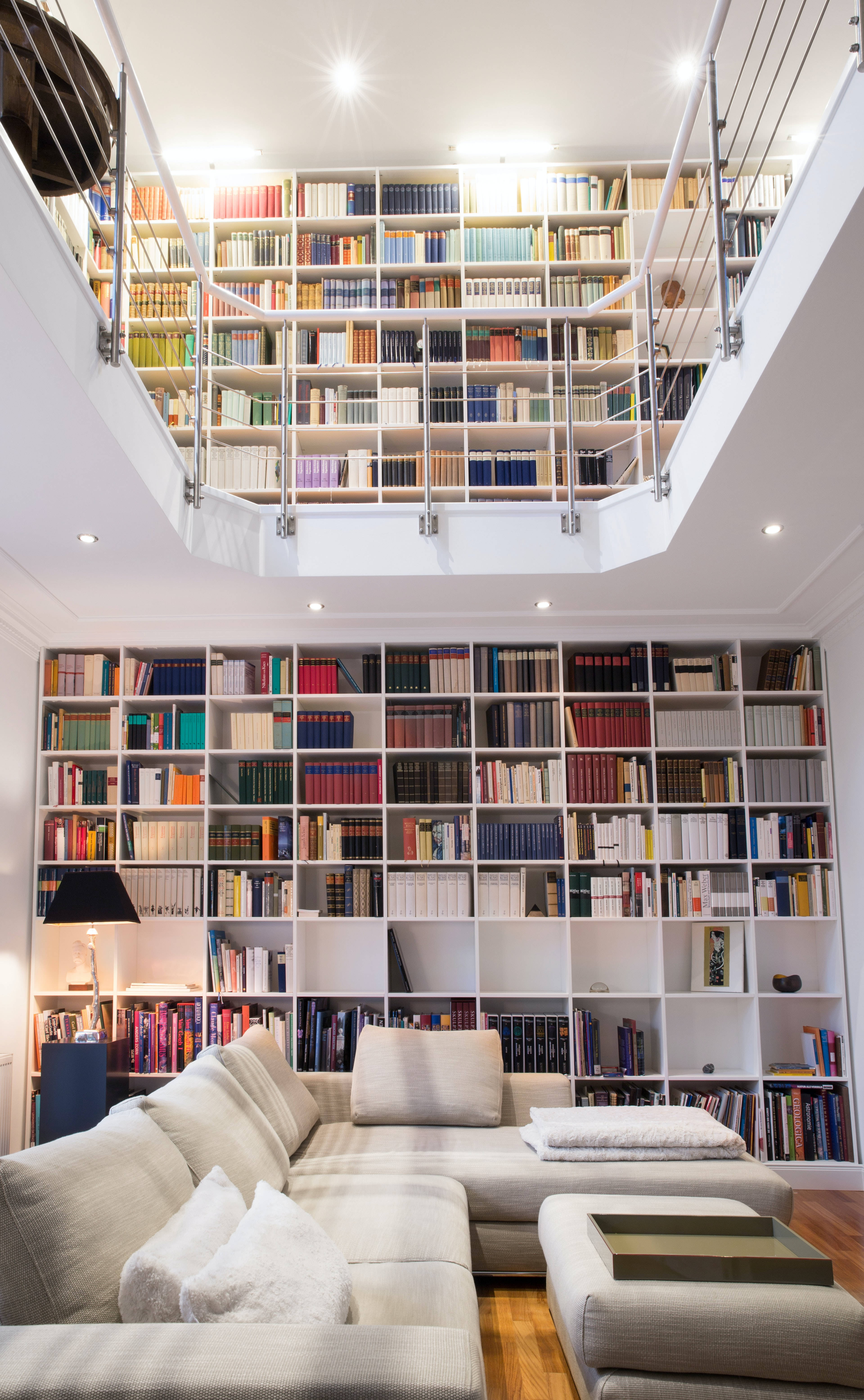 white library, massive white bookshelf wall, colorful books, 5K Phone Wallpaper