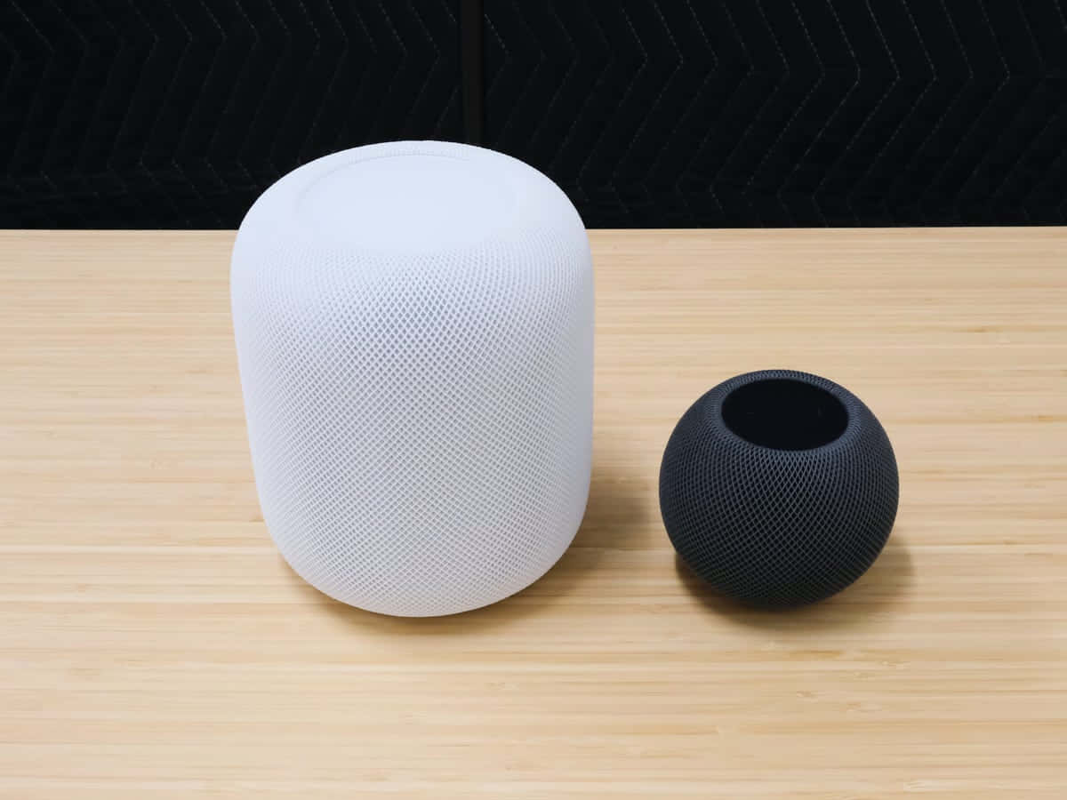 white and black Home Pod, wooden table, light wood surface, SD Desktop Wallpaper