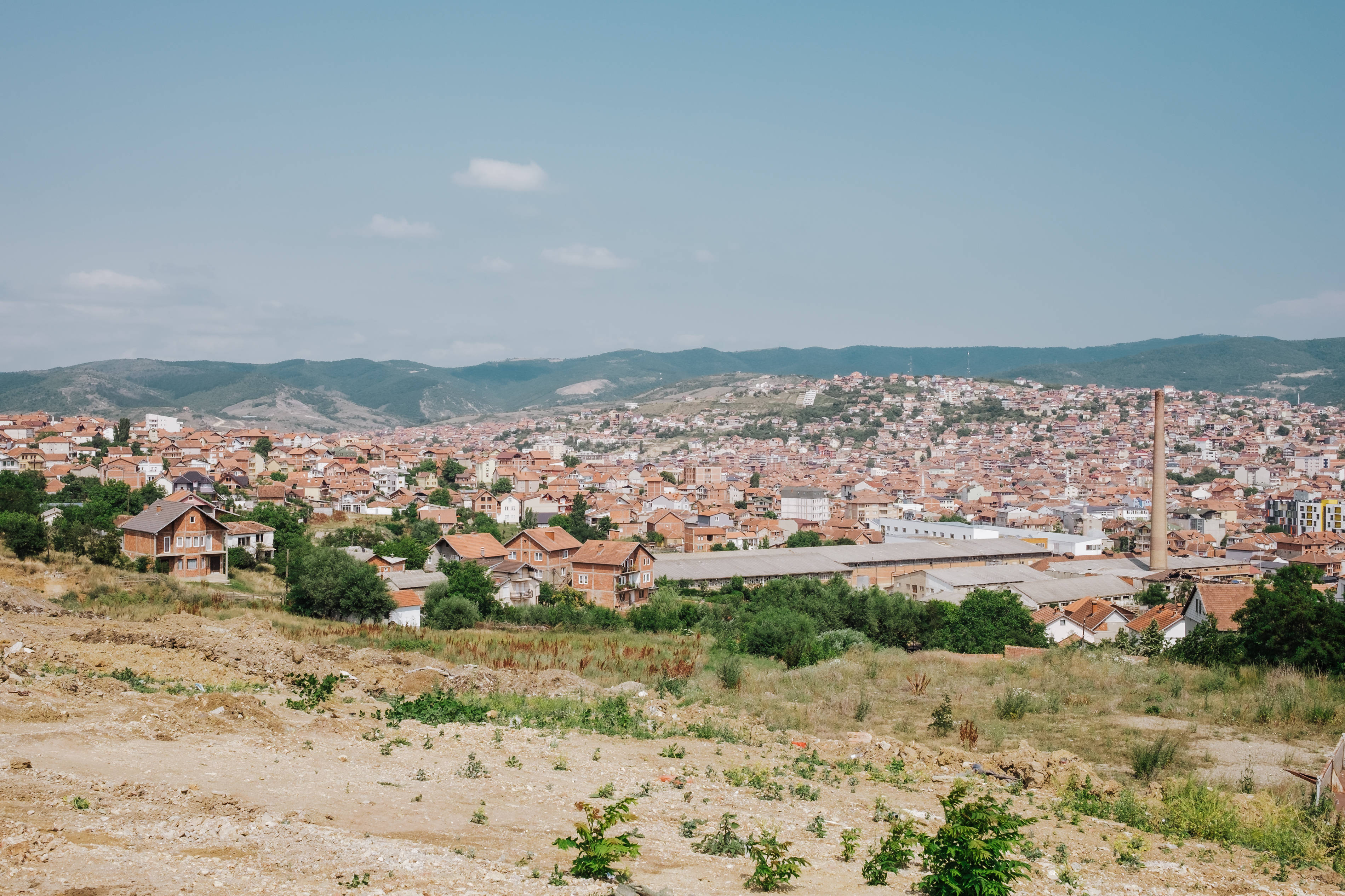village in kosovo, terracotta roofs, green hills, 2K Desktop Wallpaper