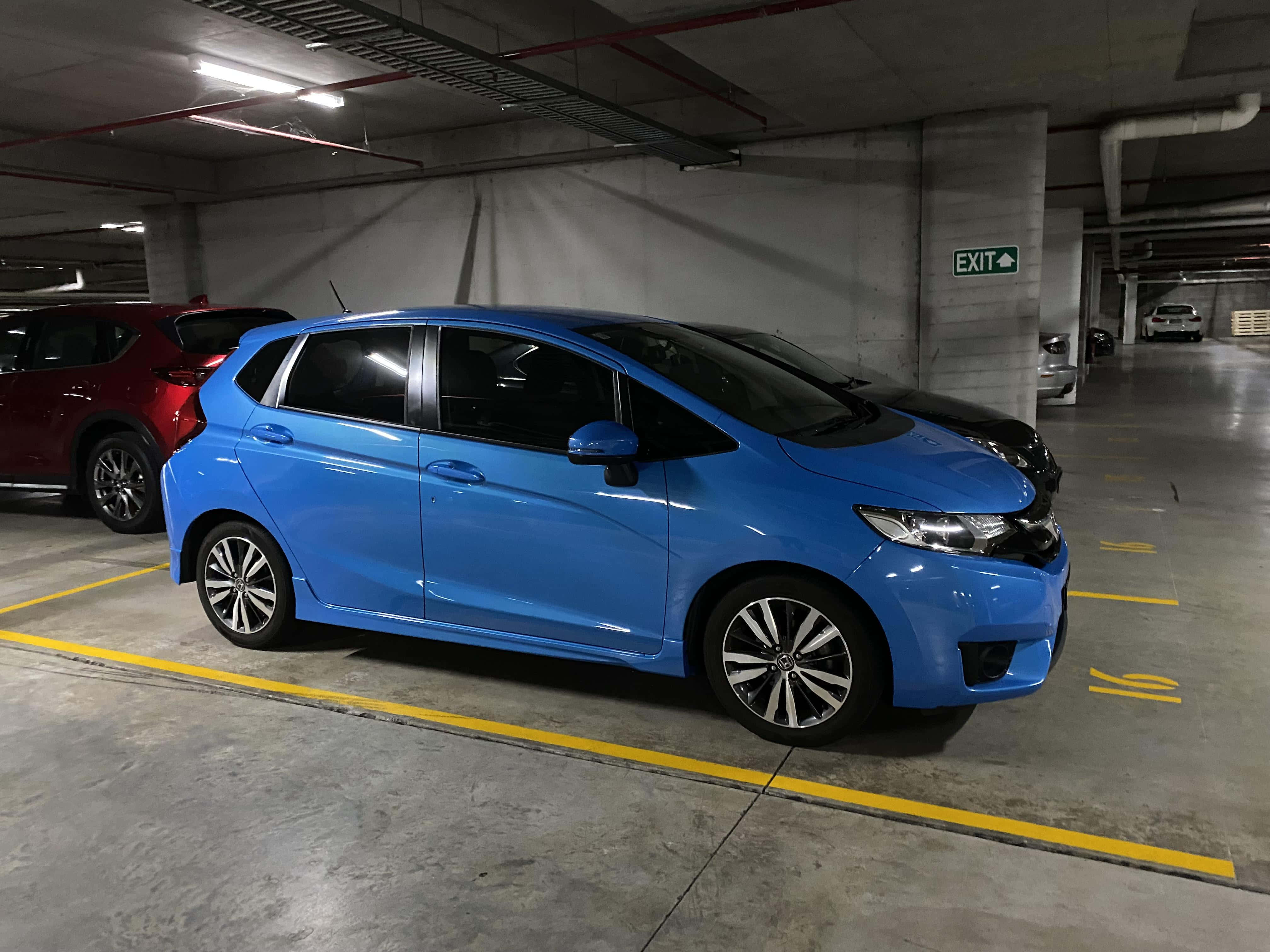 Honda Fit, vibrant blue, concrete underground parking garage, 4K Desktop Wallpaper