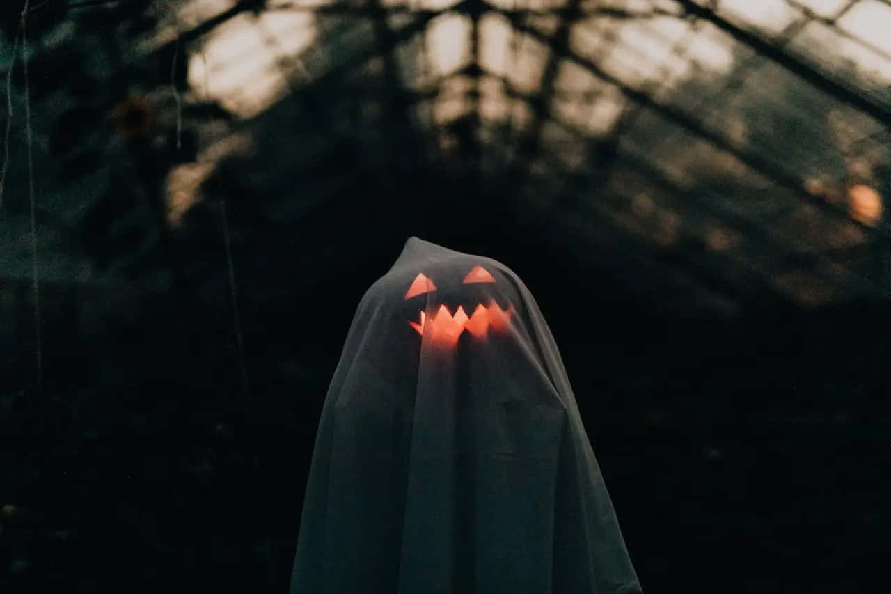 ghostly pumpkin specterin, tattered grey ghost costume, glowing jack-o'-lantern face, HD Desktop Wallpaper