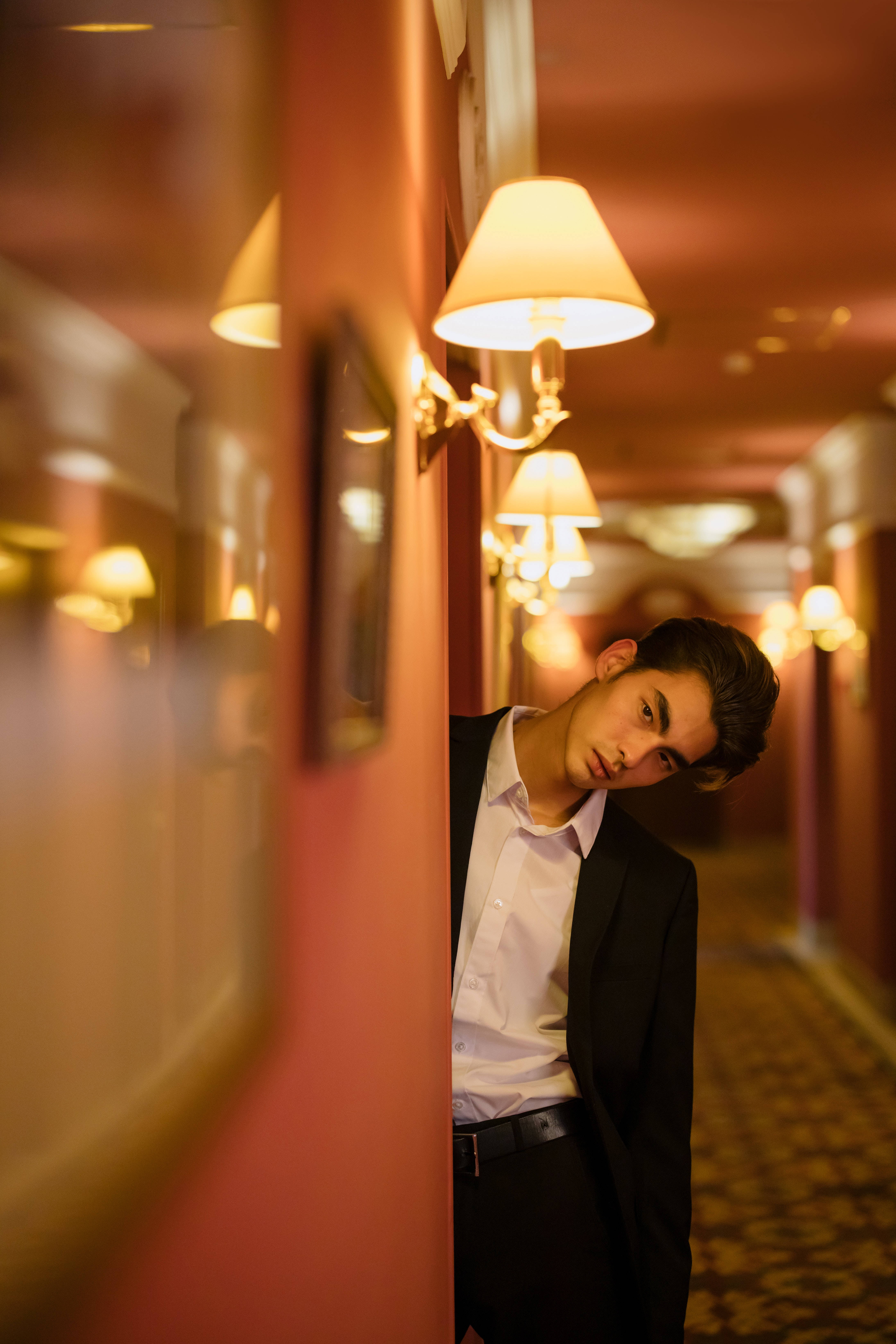 handsome man, hotel corridor, vintage sconces, 5K Phone Wallpaper