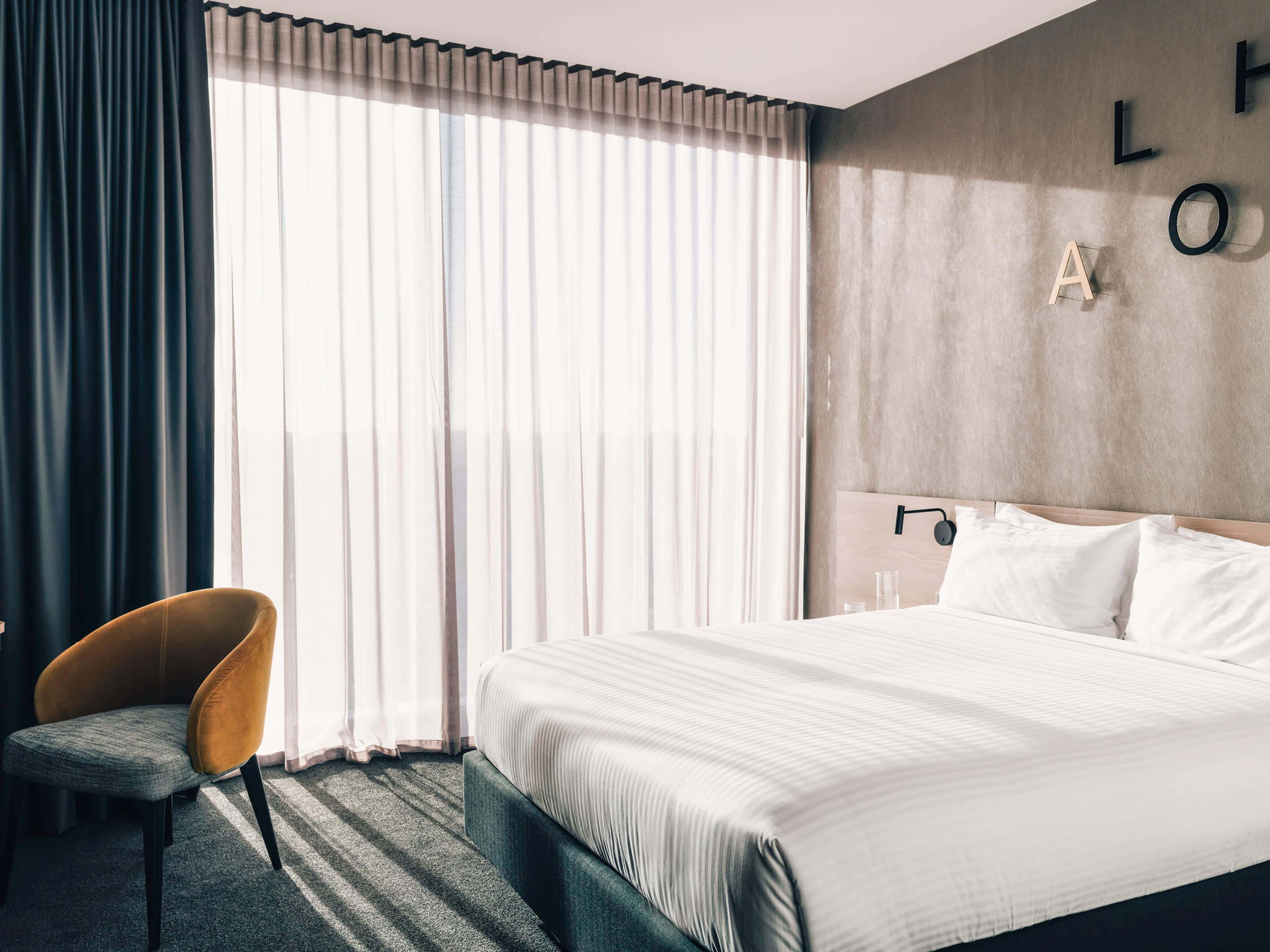 modern hotel room, neatly made bed, sheer curtains, 4K Desktop Wallpaper