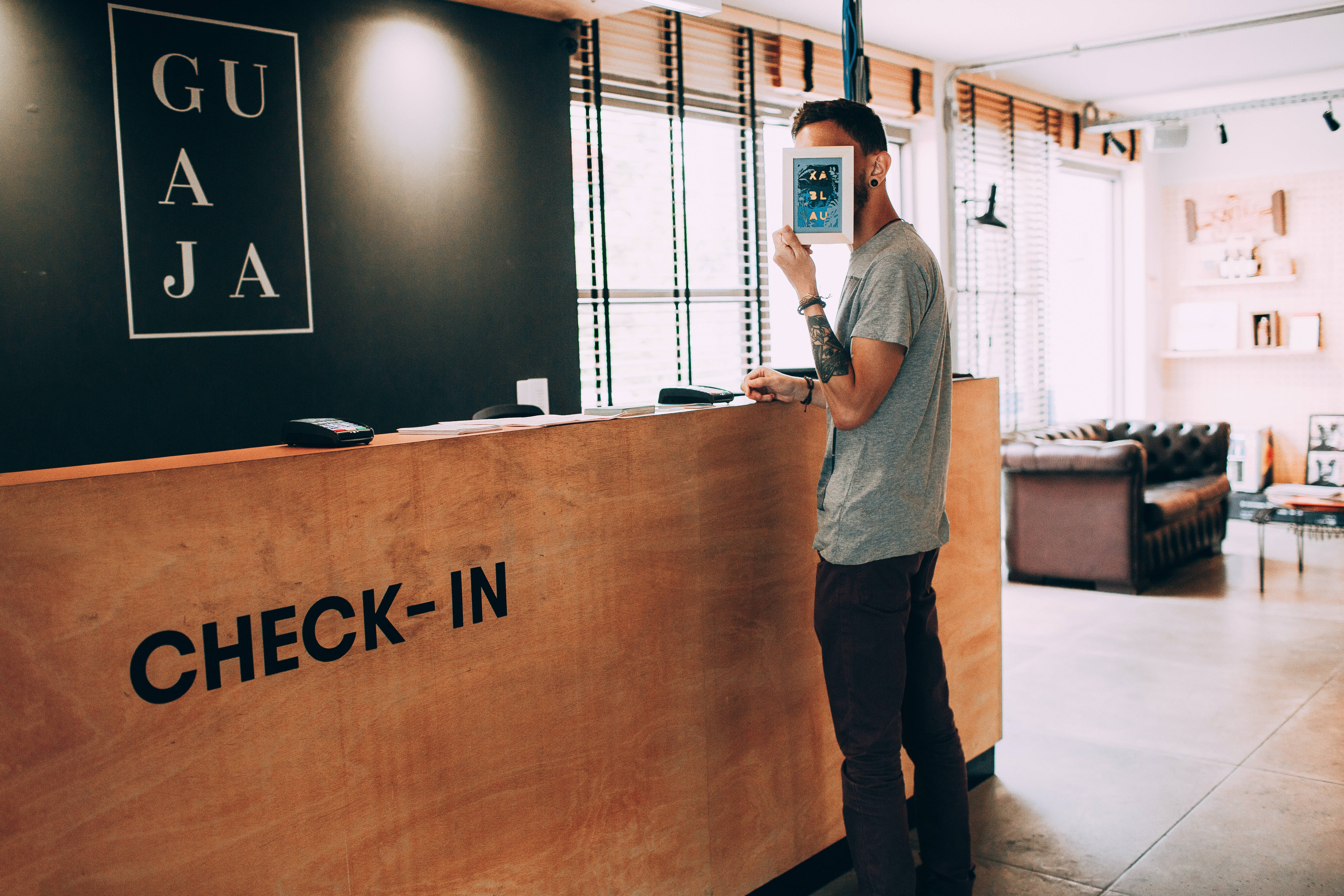 hotel lobby, modern wooden check-in desk, large windows, 5K Desktop Wallpaper