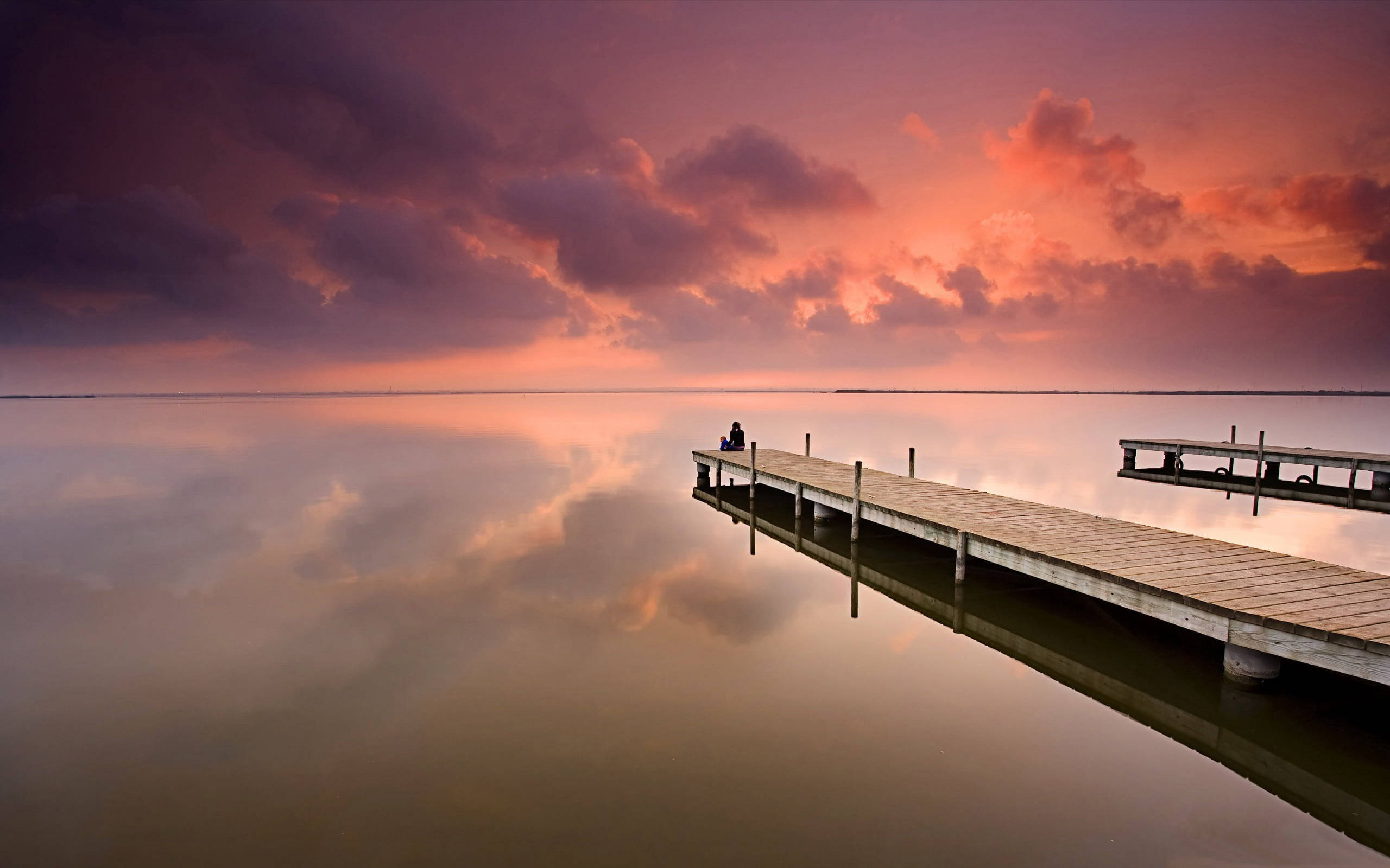 calm sea, wooden pier, dramatic sunset, 2K Desktop Wallpaper