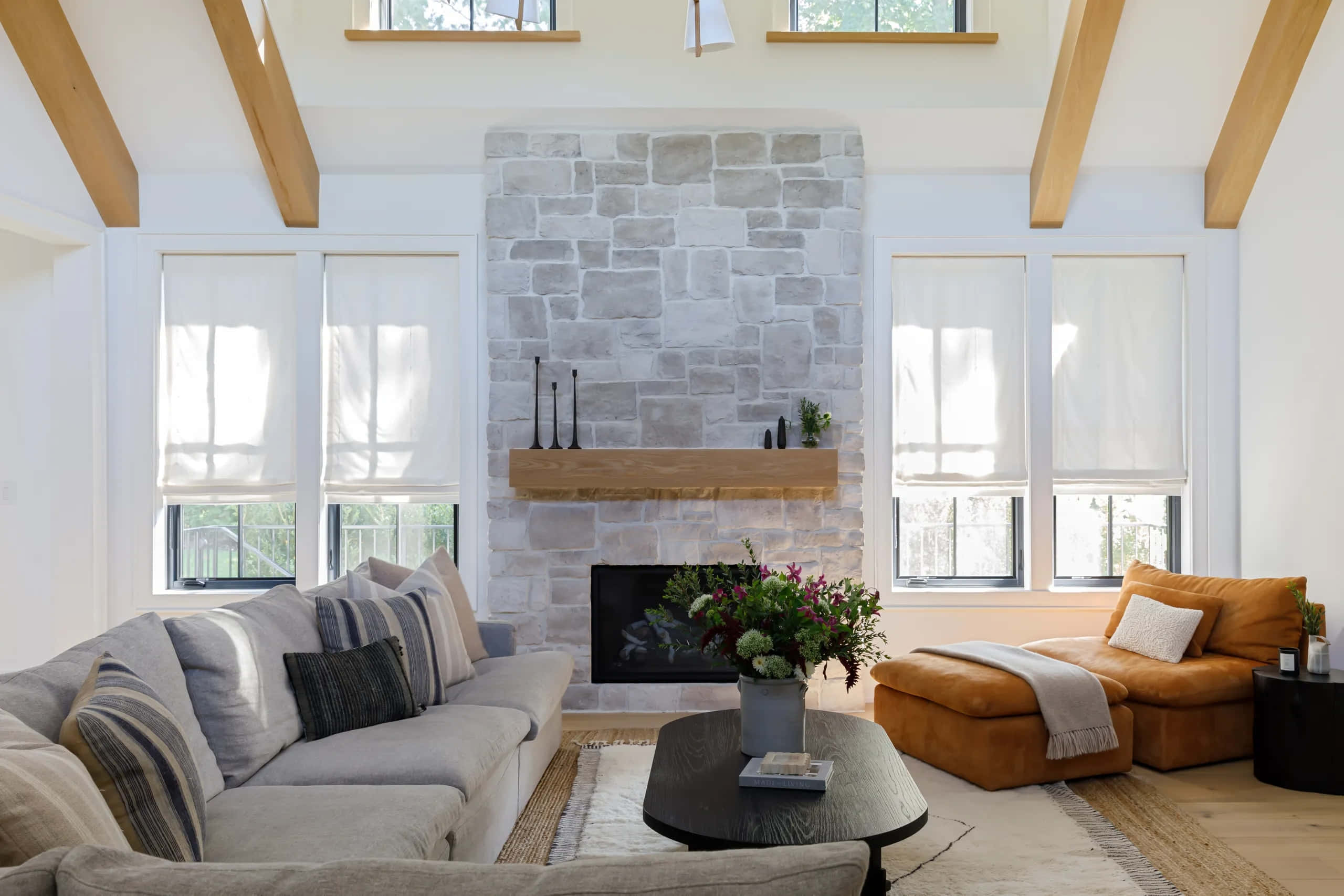 modern living room, stone fireplace, wooden beams, 2K Desktop Wallpaper