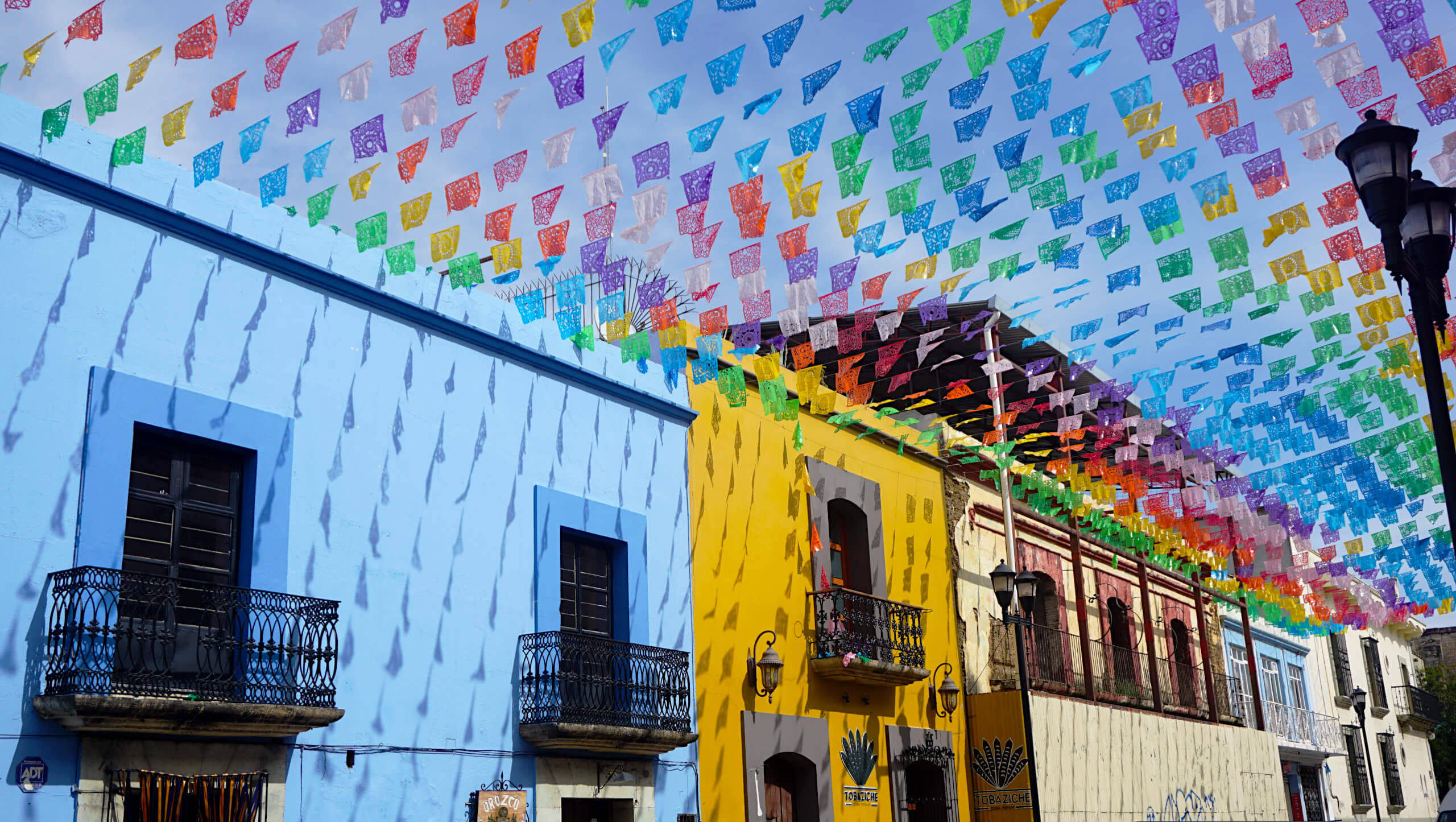colorful buntings, houses in Oaxaca, papel picado banners, 2K Desktop Wallpaper