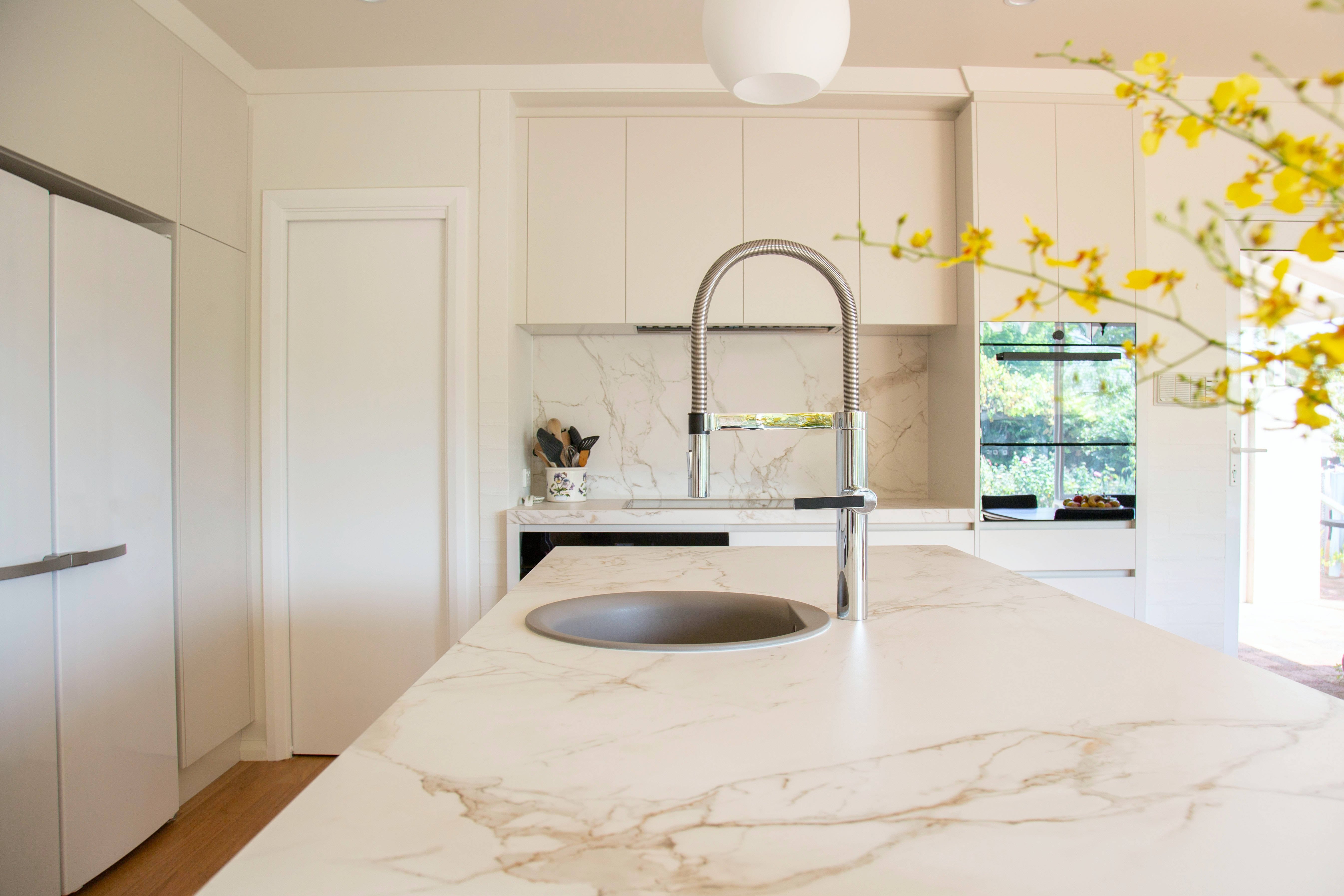 white marble countertops, curved faucet, yellow blossoms, 5K Desktop Wallpaper