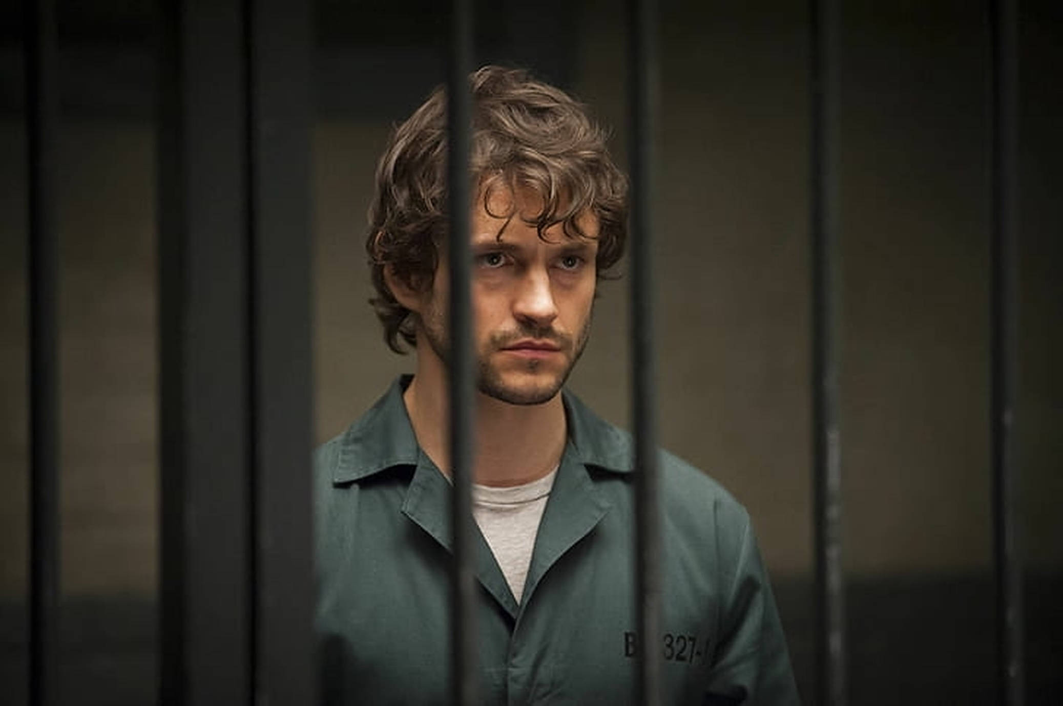Hugh Dancy, green prison uniform, metal bars, Full HD Desktop Wallpaper