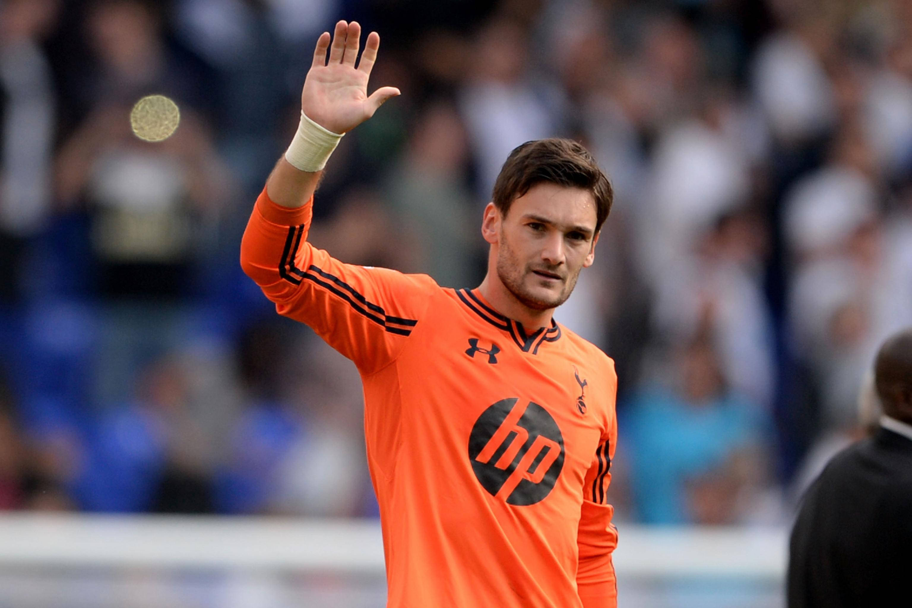 Hugo Lloris, bright orange jersey, coin mid-air, 2K Desktop Wallpaper