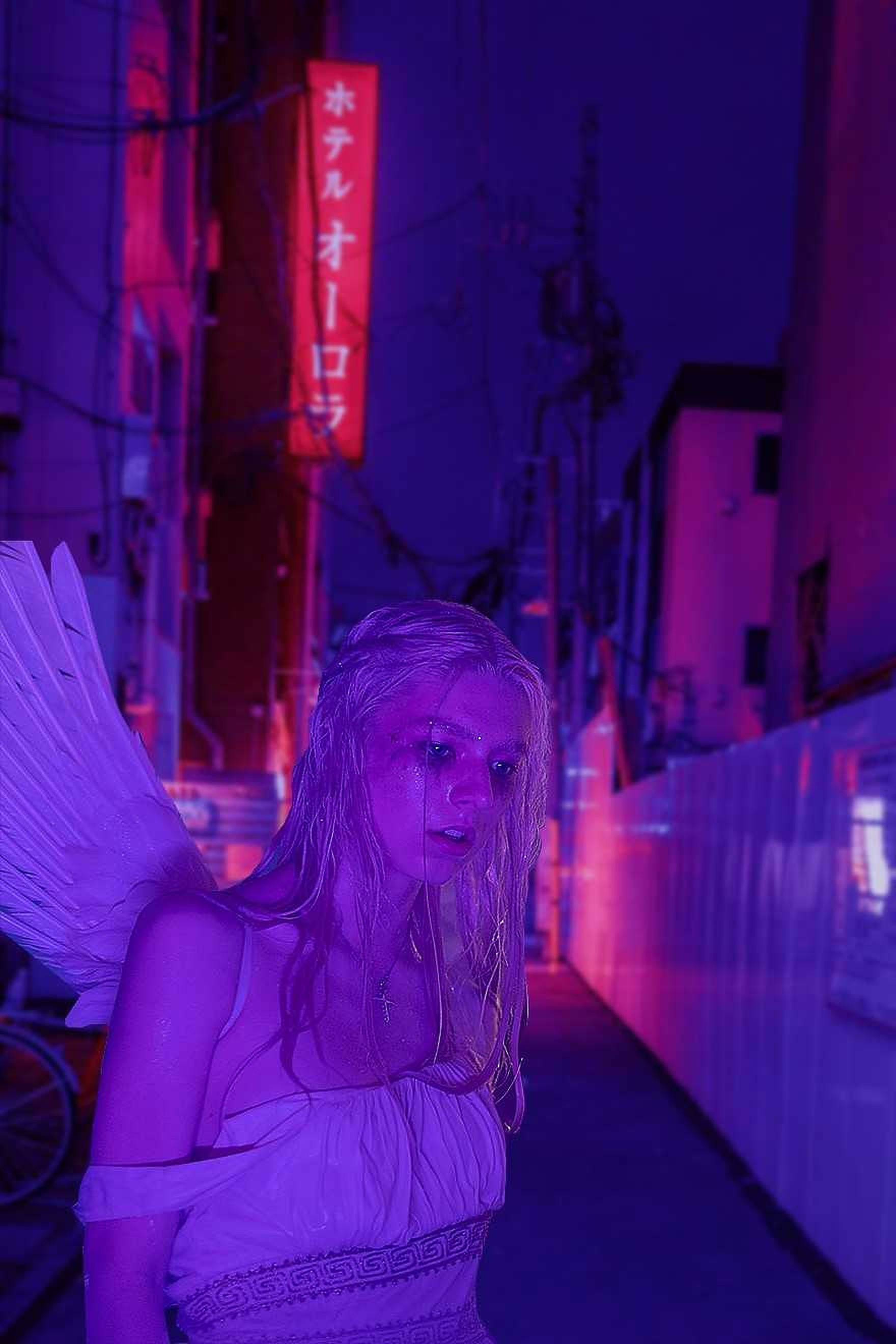 Hunter Schafer, angel wings, neon-drenched alleyway, 2K Phone Wallpaper
