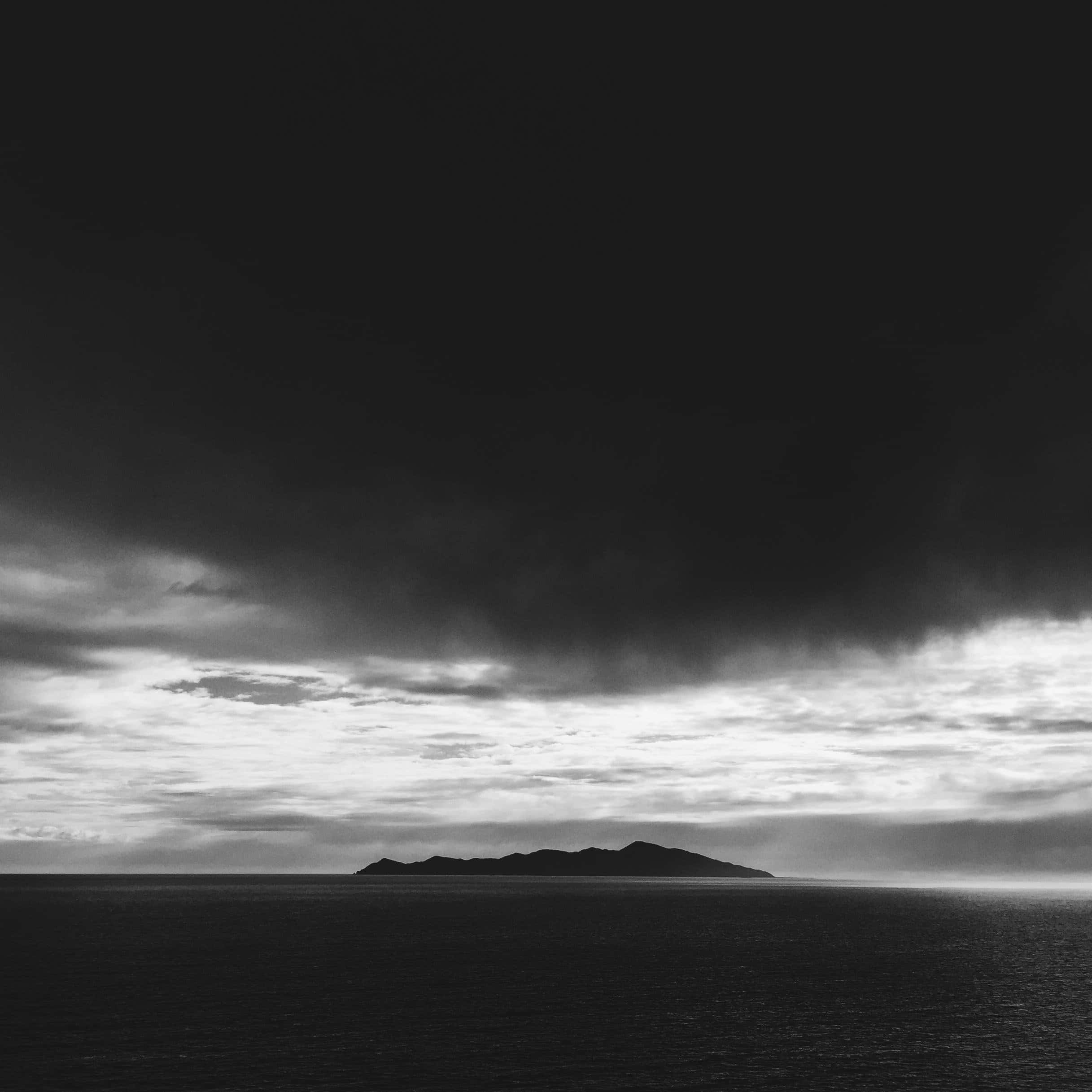 black and white seascape, distant island silhouette, heavy storm cloud canopy, Full HD Desktop Wallpaper