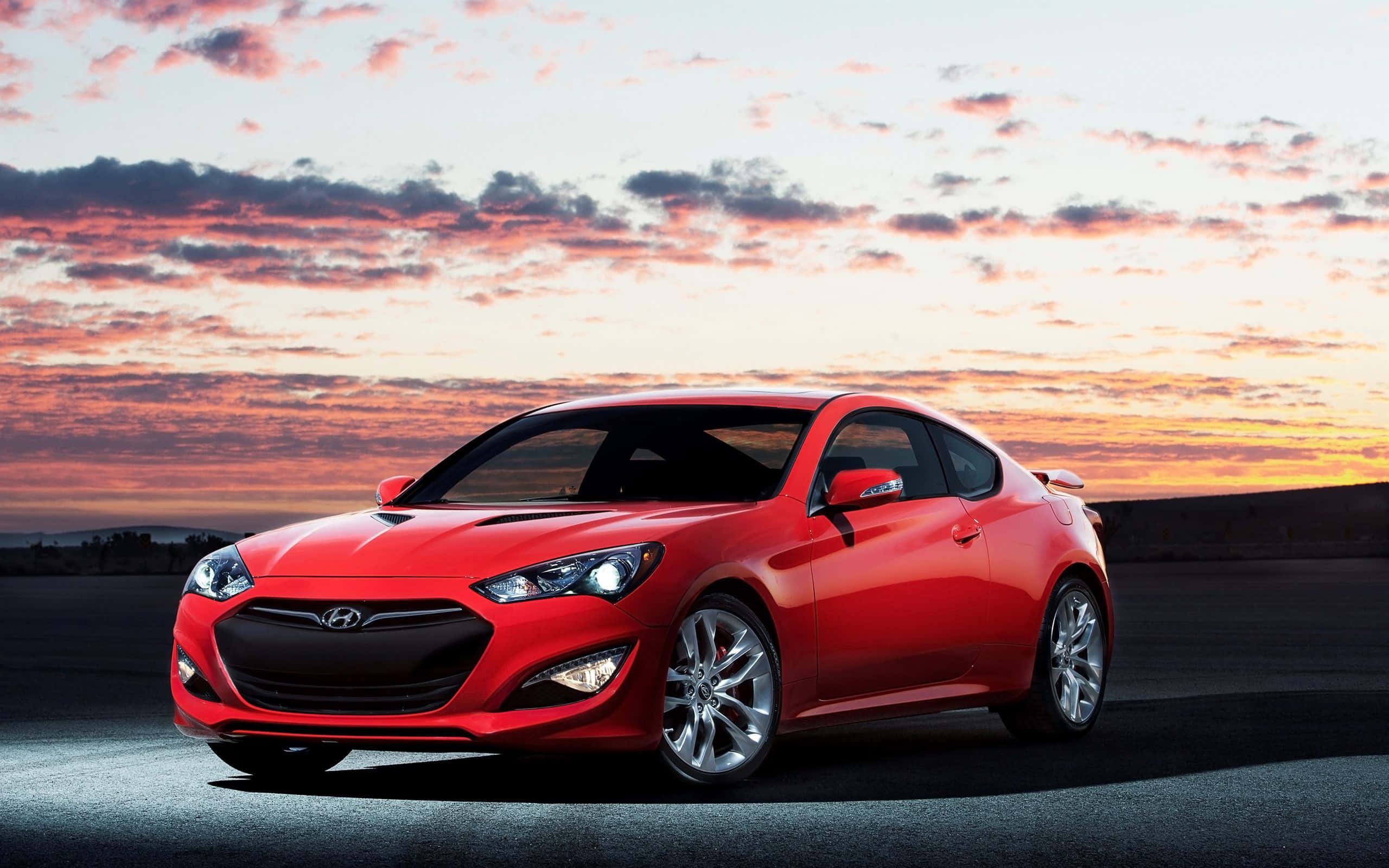Hyundai Genesis, vibrant red, dramatic sunset sky, 2K Desktop Wallpaper