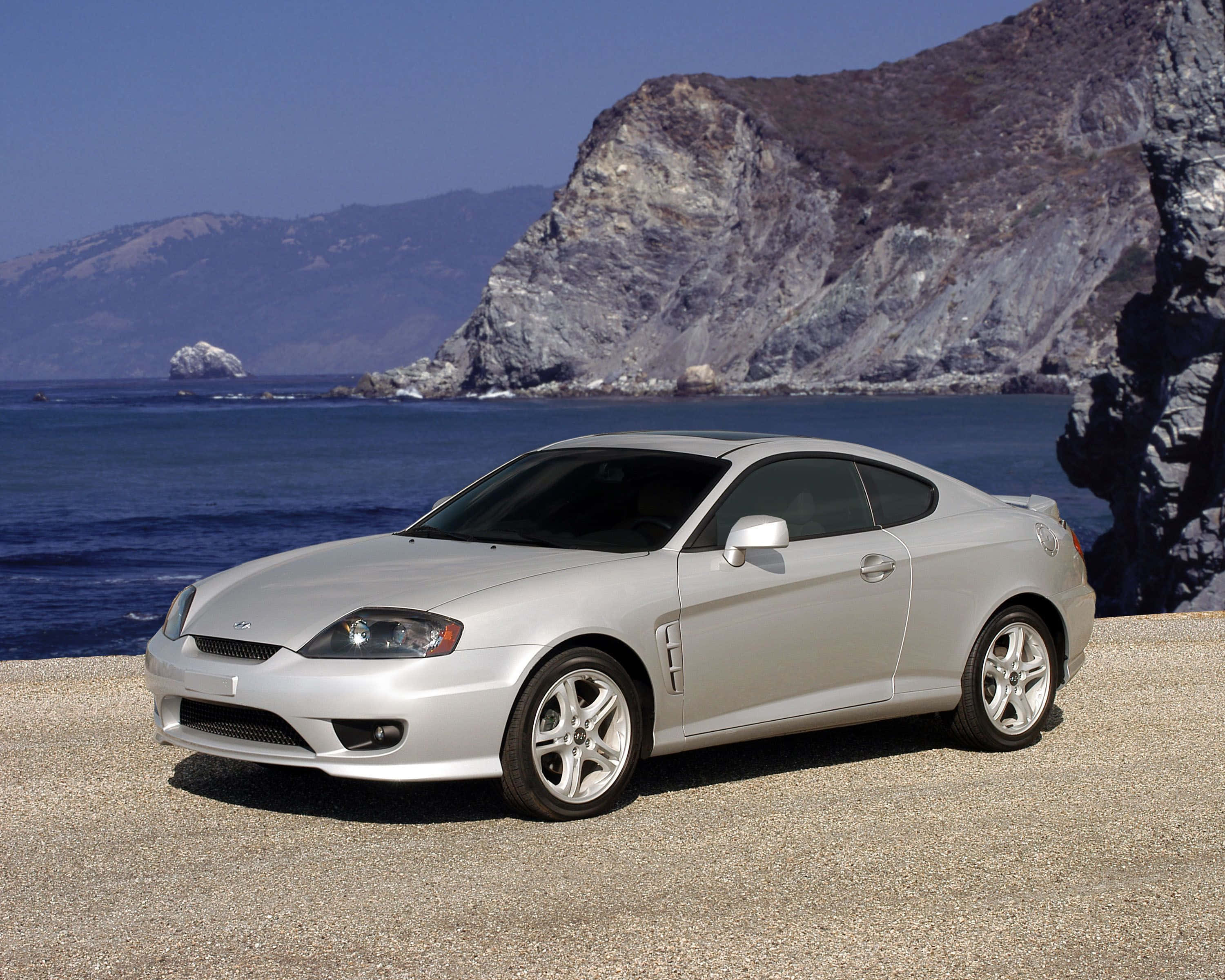 Hyundai Tiburon, silver, gravel cliffside, 2K Desktop Wallpaper