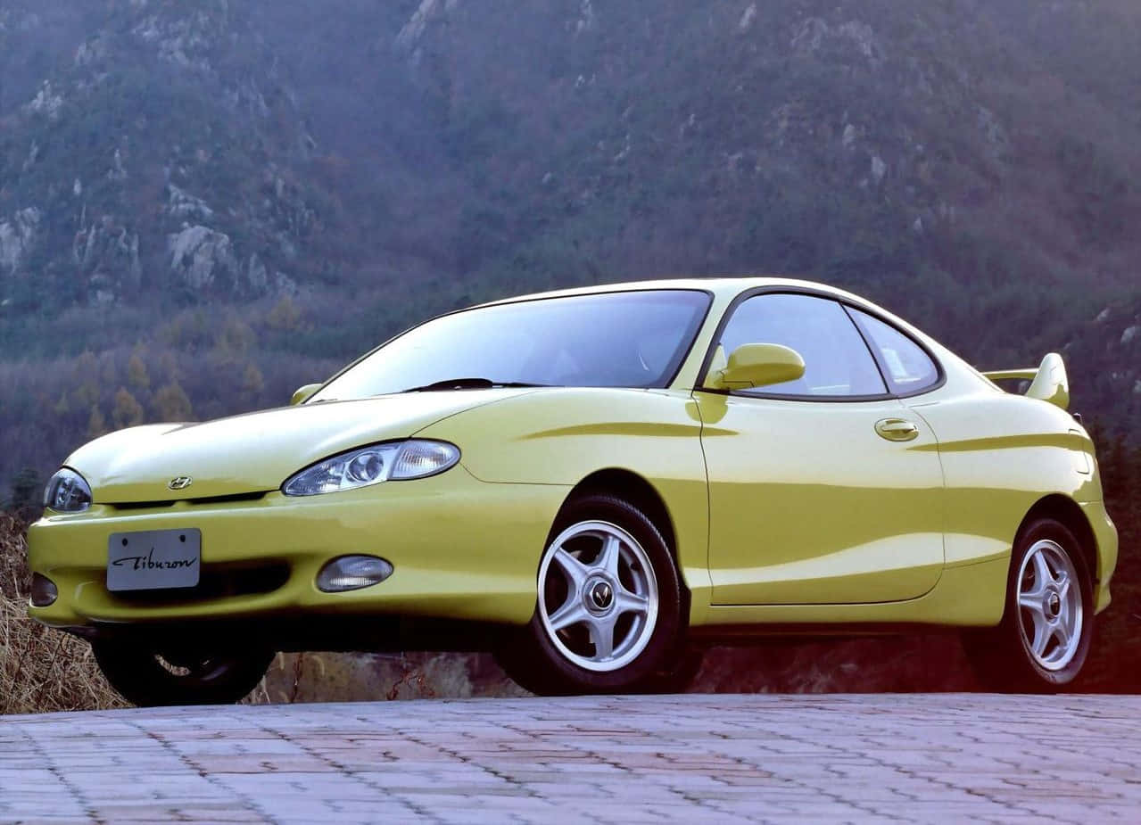 Hyundai Tiburon, vibrant yellow, stone path, SD Desktop Wallpaper
