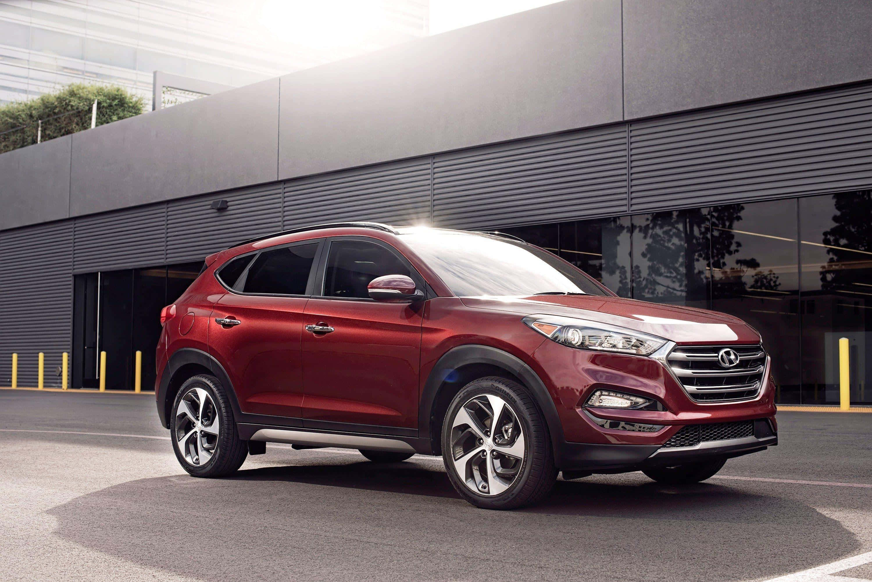 Hyundai Tucson, glossy red, modern gray building, 2K Desktop Wallpaper