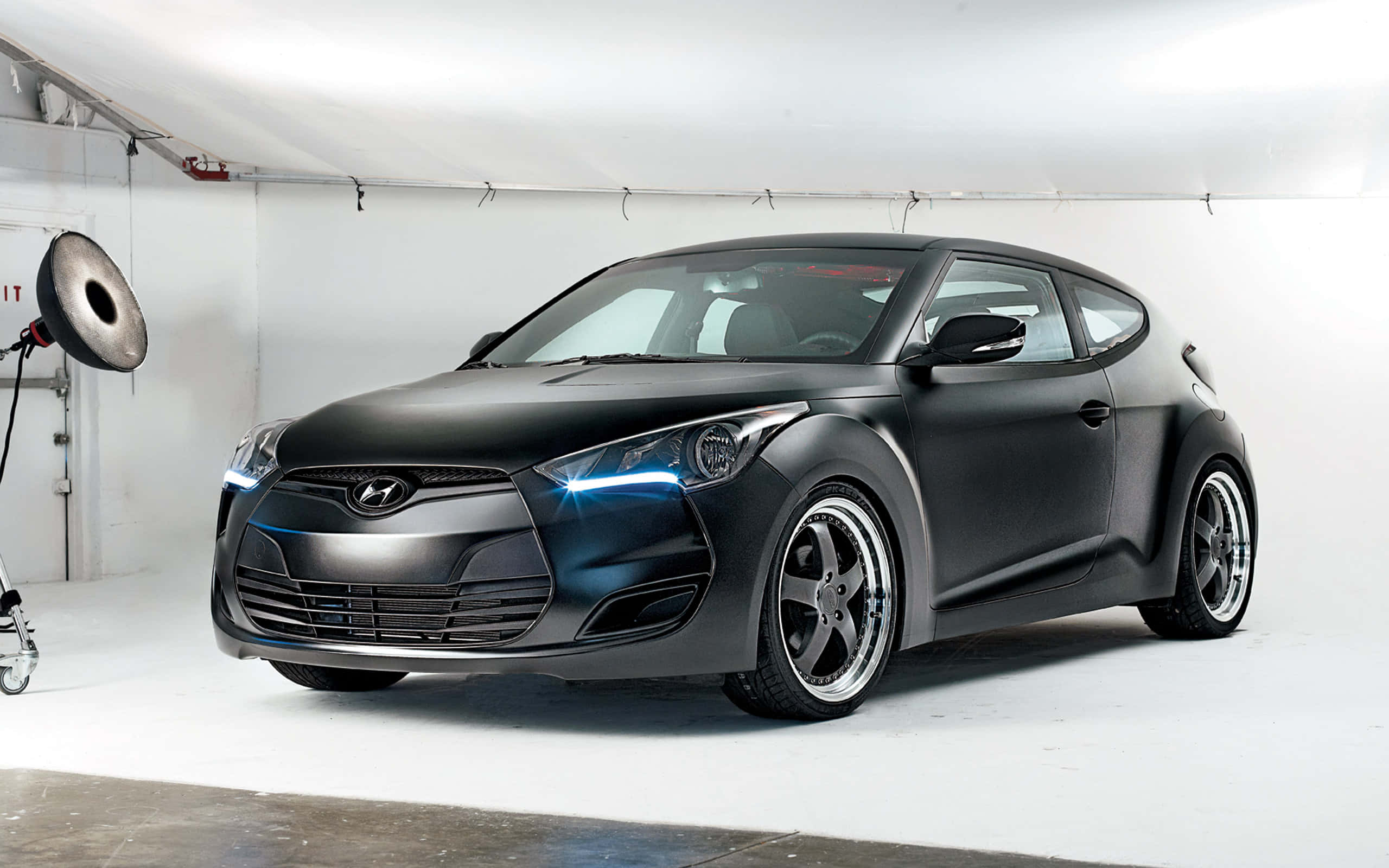 Hyundai Veloster, matte black, glowing blue headlights, 2K Desktop Wallpaper