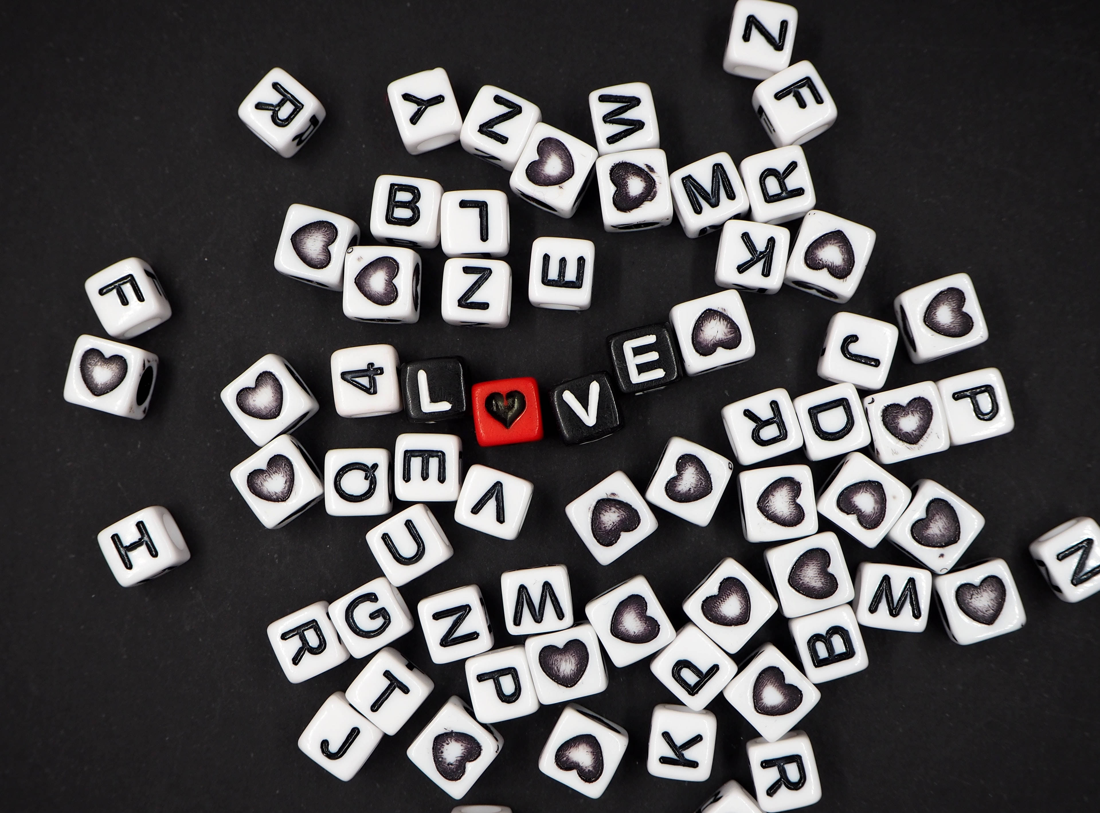 love inscription on dices, white lettered cubes, hearts scattered, 2K Desktop Wallpaper