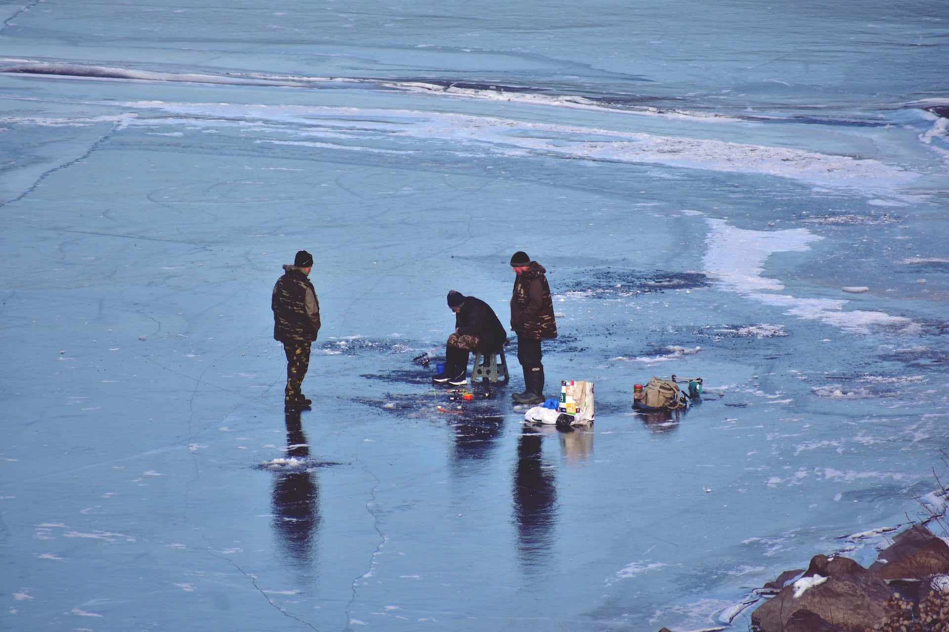 ice fishing, vast cracked blue ice lake, snow-dusted rocks, Full HD Desktop Wallpaper