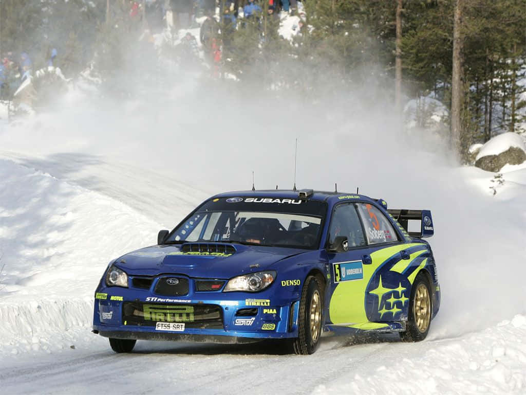 Subaru rally car, blue and lime green, snowy forested mountain road, SD Desktop Wallpaper