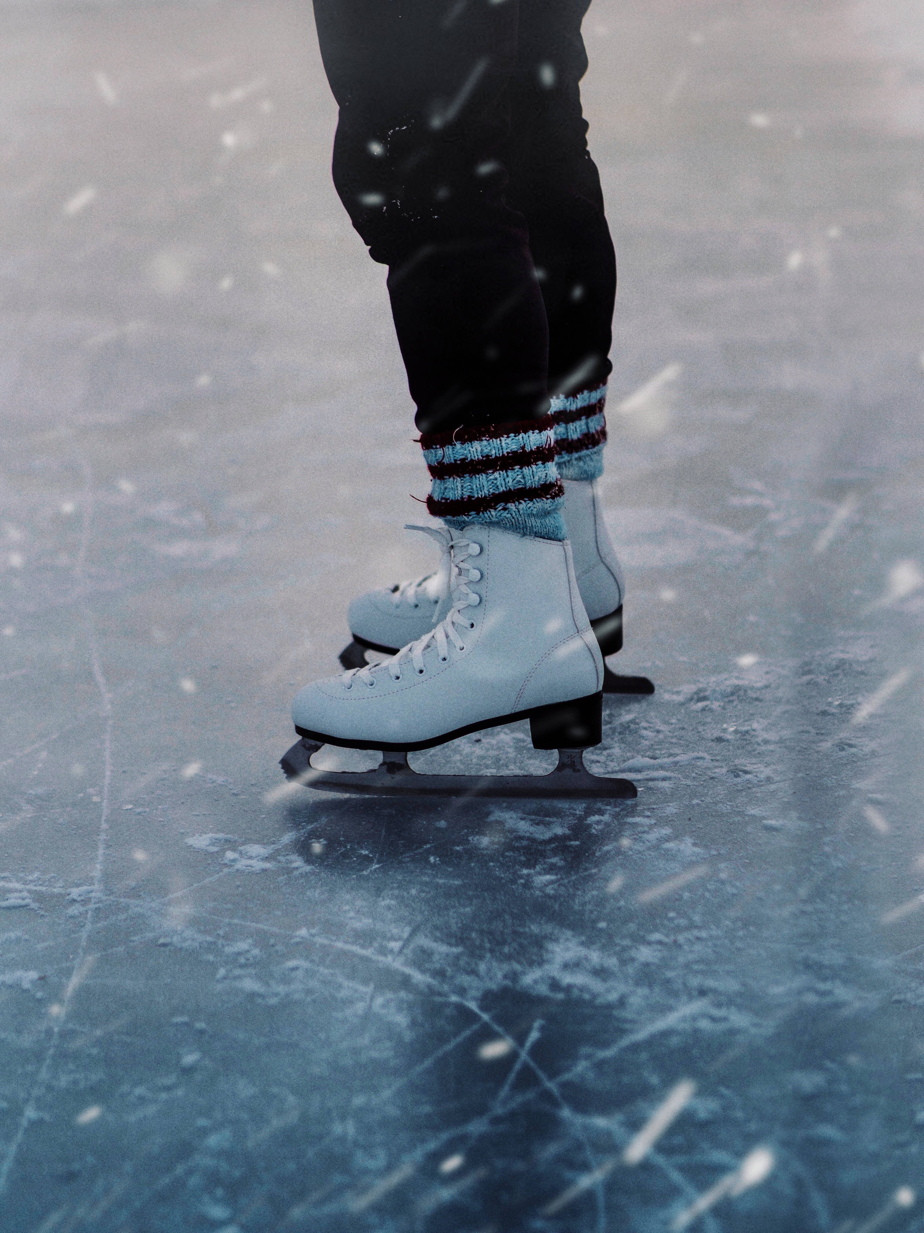 white ice skates, snowy ice rink, falling snowflakes, 4K Phone Wallpaper