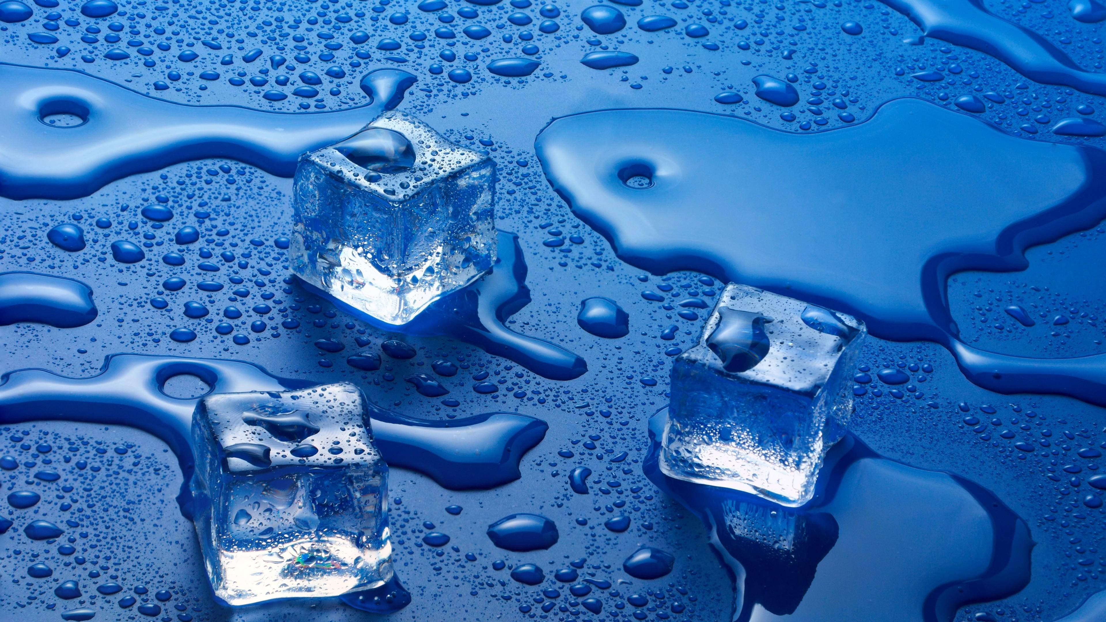 three defrosted ice cubes, glossy blue puddle, glistening droplets, 4K Desktop Wallpaper