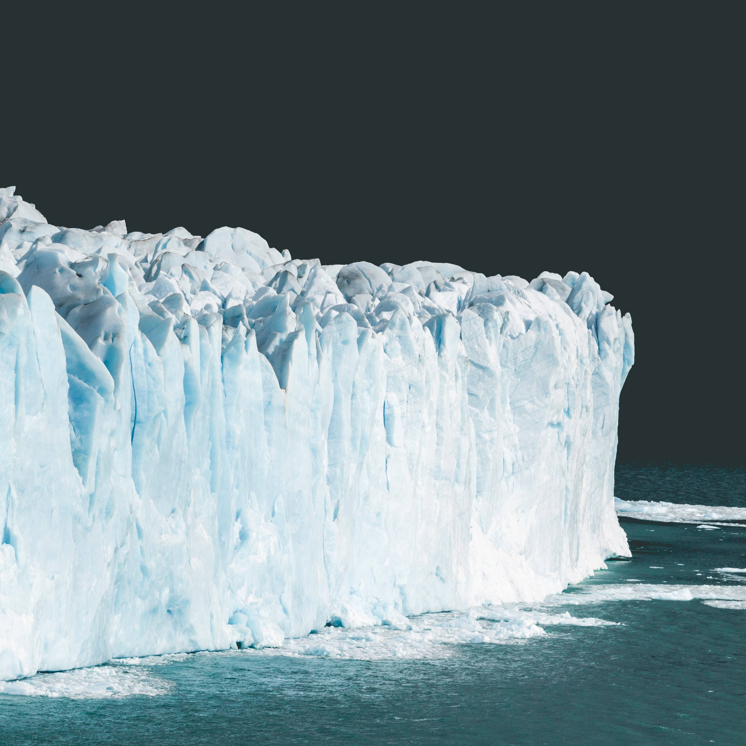 glacier wall, jagged blue-white ice faces, dark teal water, Full HD Desktop Wallpaper