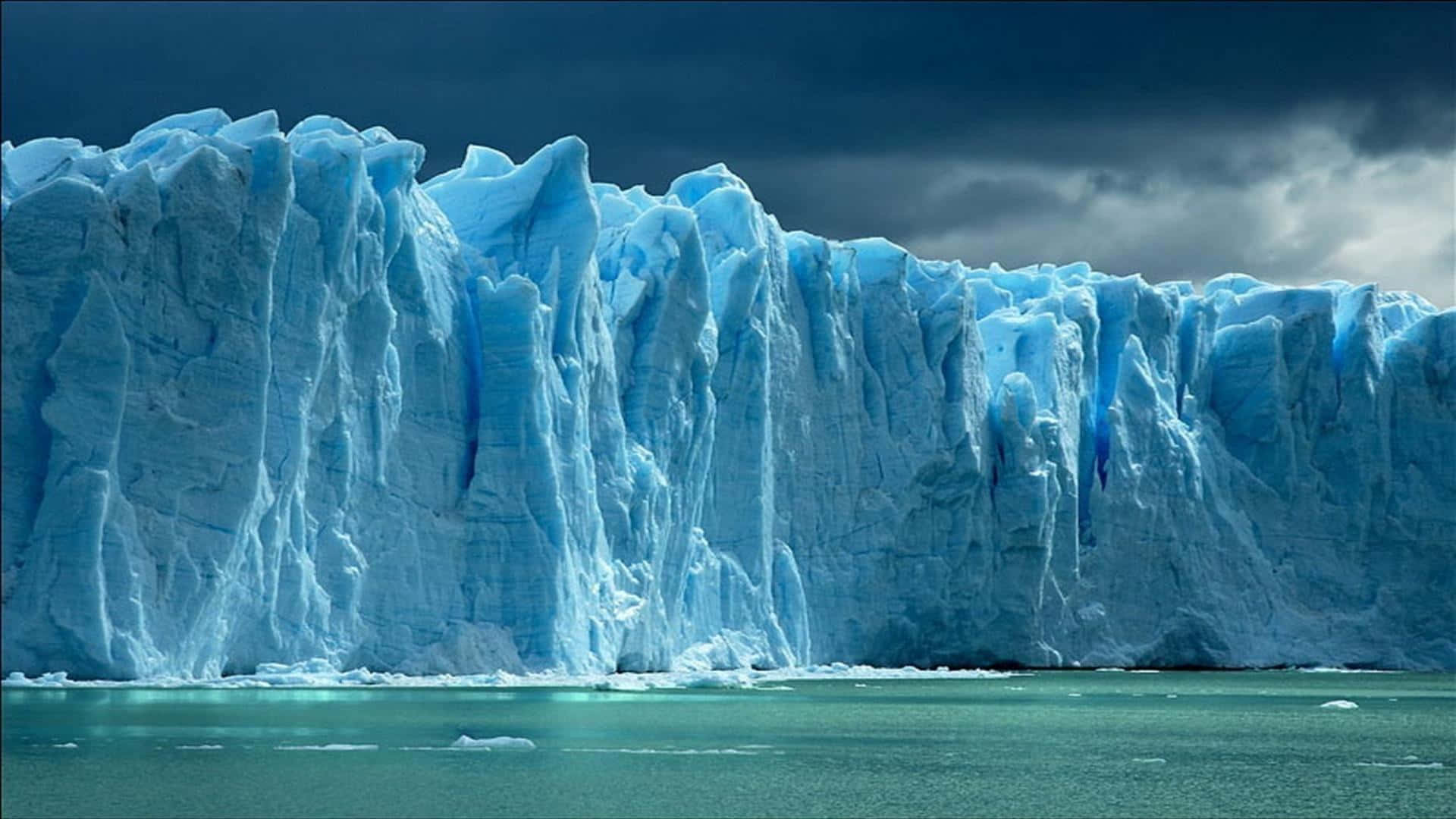 Iceberg, crystalline blue waters, jagged blue ice faces, Full HD Desktop Wallpaper