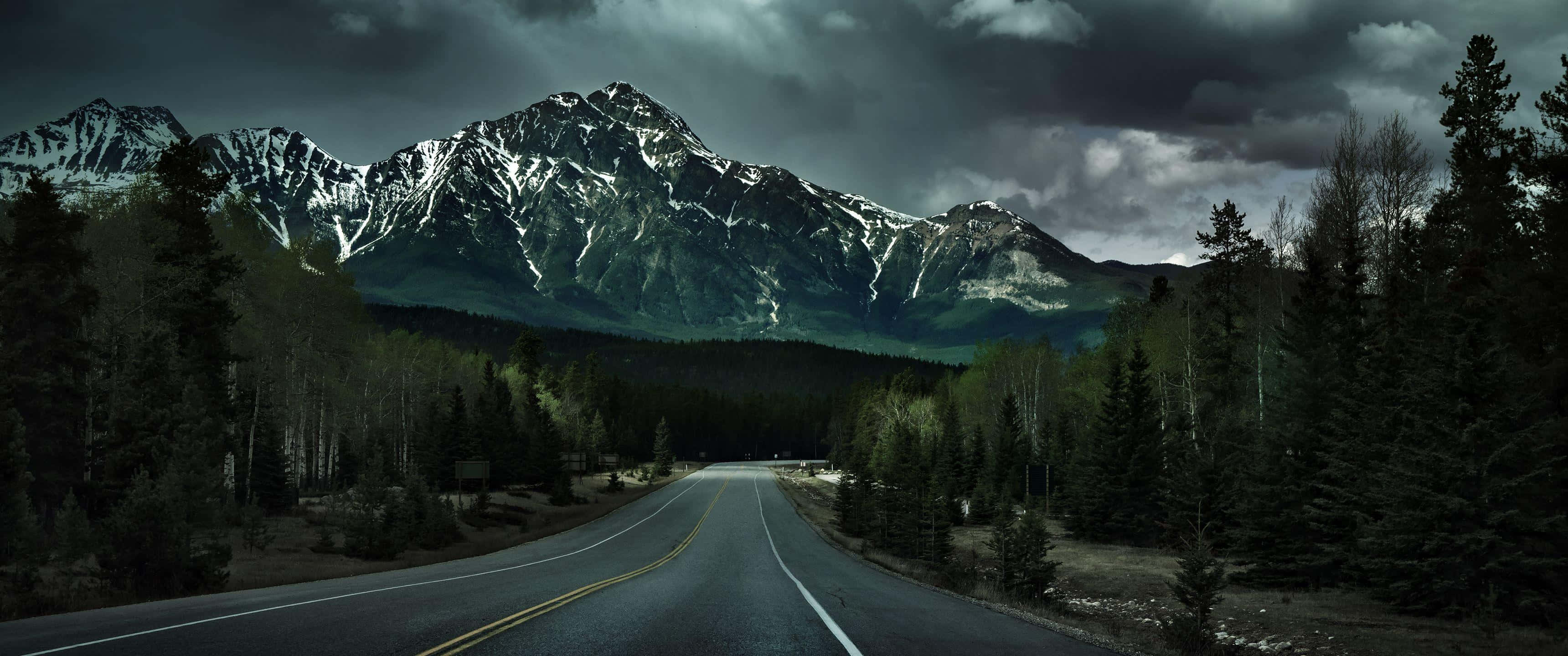 3440x1440 UHD, asphalt road, snow-capped mountains, 2K Desktop Wallpaper