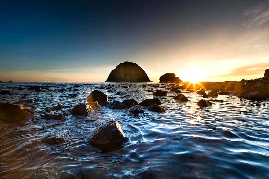 Sunset, rocky shoreline, waves lapping stones, SD Desktop Wallpaper