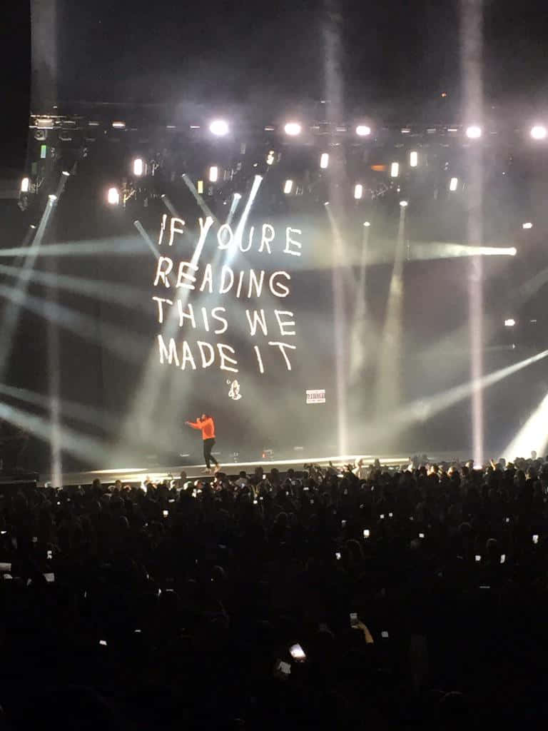 IF YOU'RE READING THIS WE MADE IT, orange shirt, dimly lit stage, SD Phone Wallpaper
