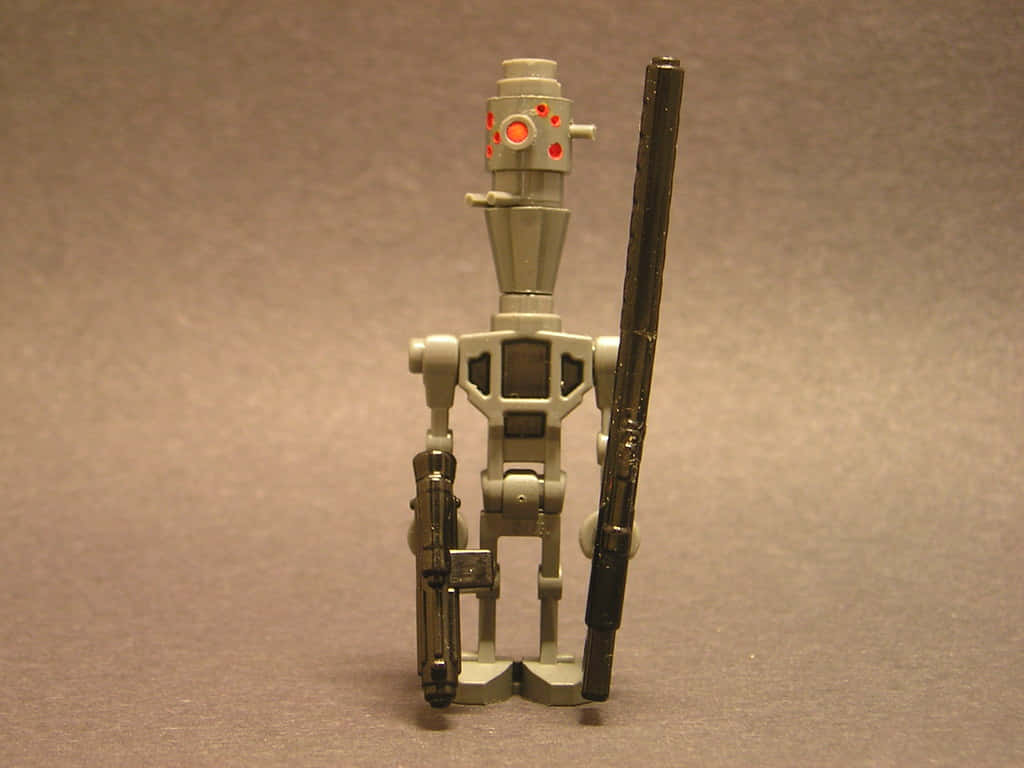 IG-88, gray plastic robot toy, glowing red eyes, SD Desktop Wallpaper