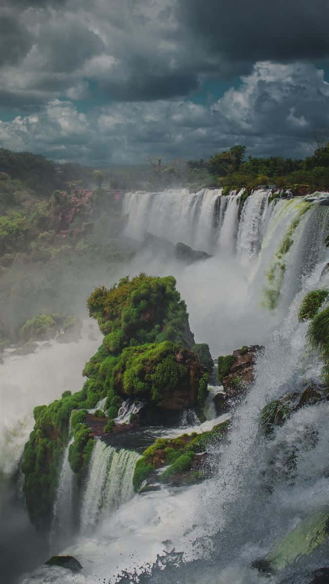 Iguazu Falls, mossy cliffs, dramatic cloudy sky, SD Phone Wallpaper