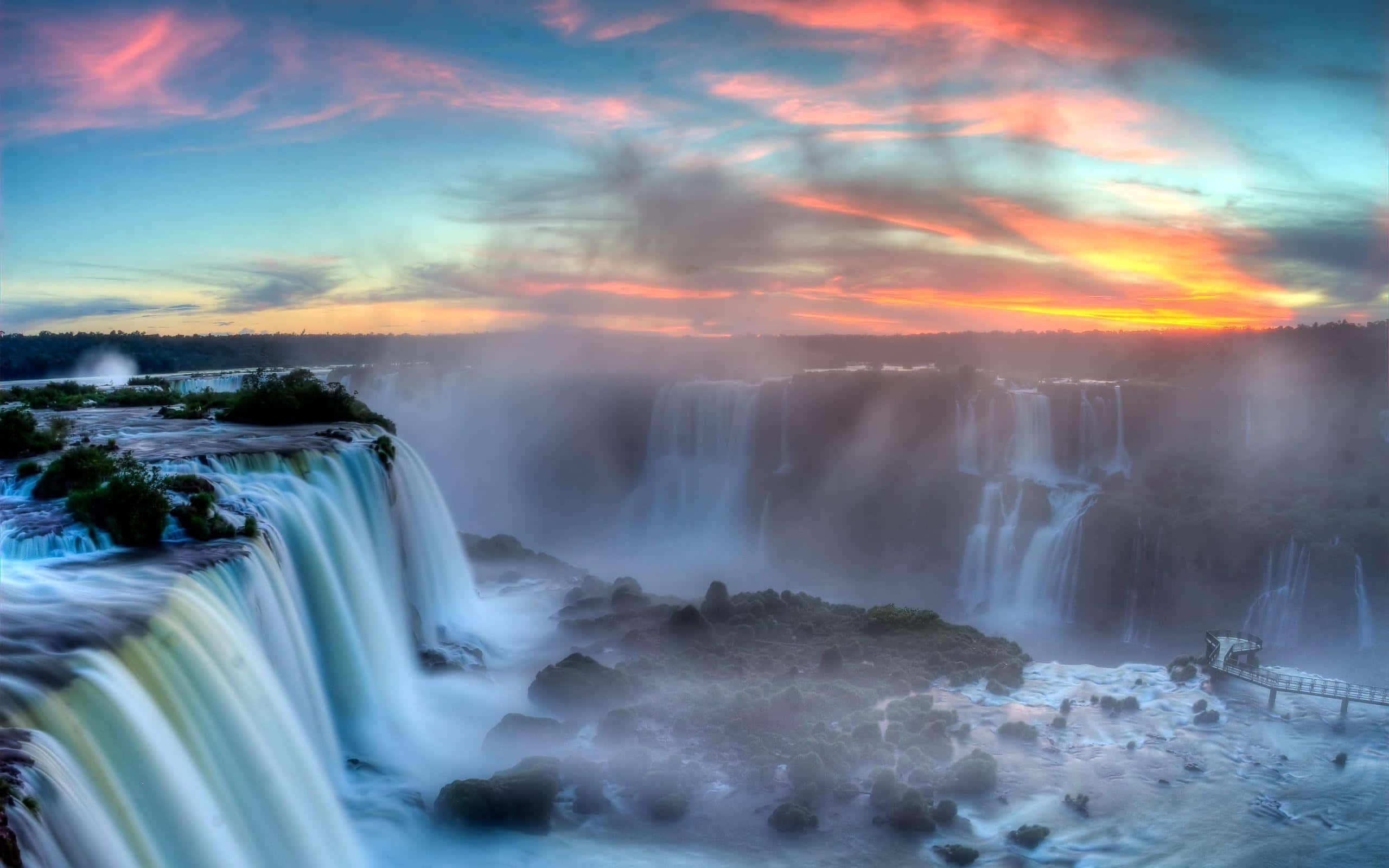 Iguazu Falls, vibrant sunset sky, streaked clouds, 2K Desktop Wallpaper