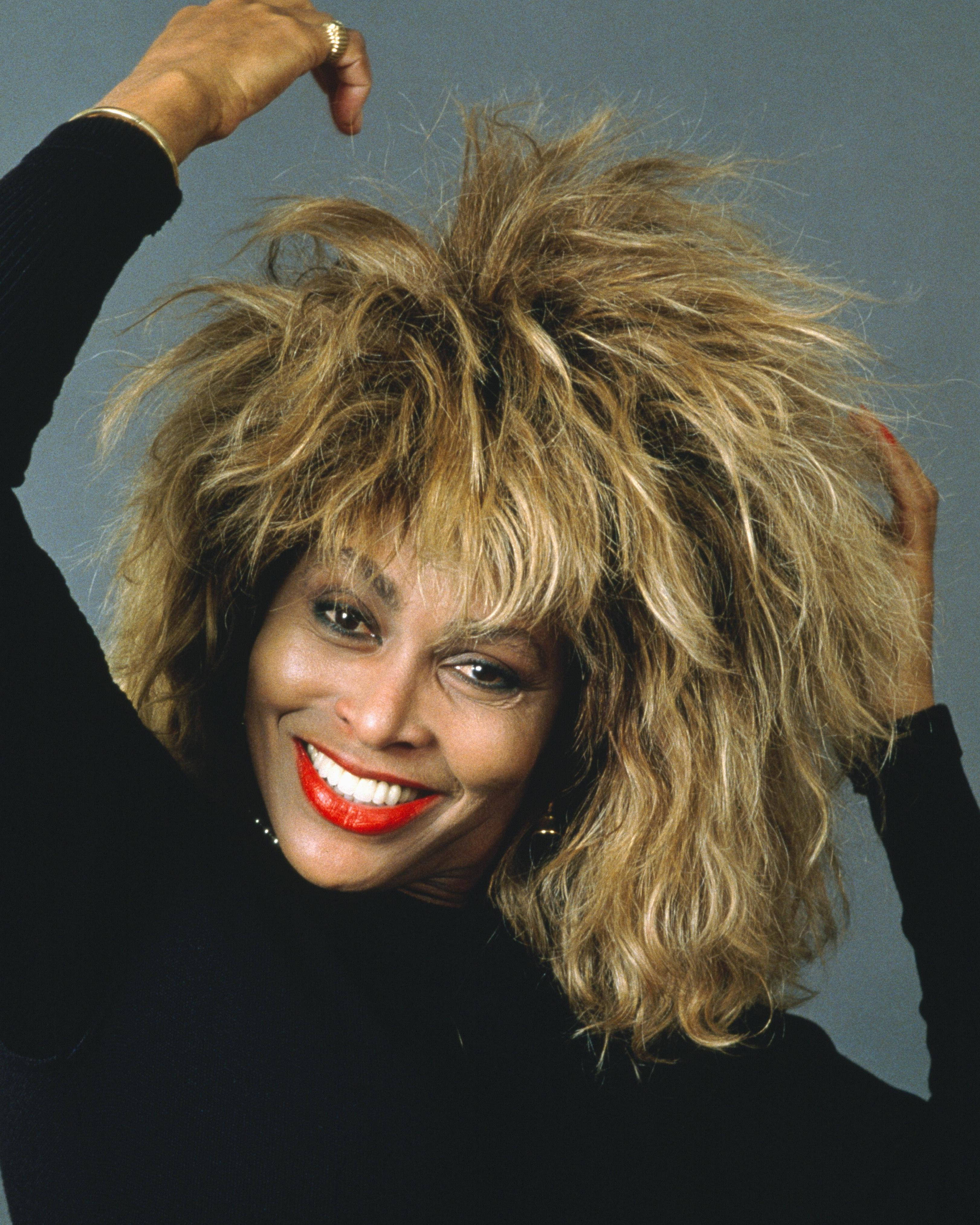 Tina Turner, American singer icon, voluminous blonde hair, 4K Phone Wallpaper