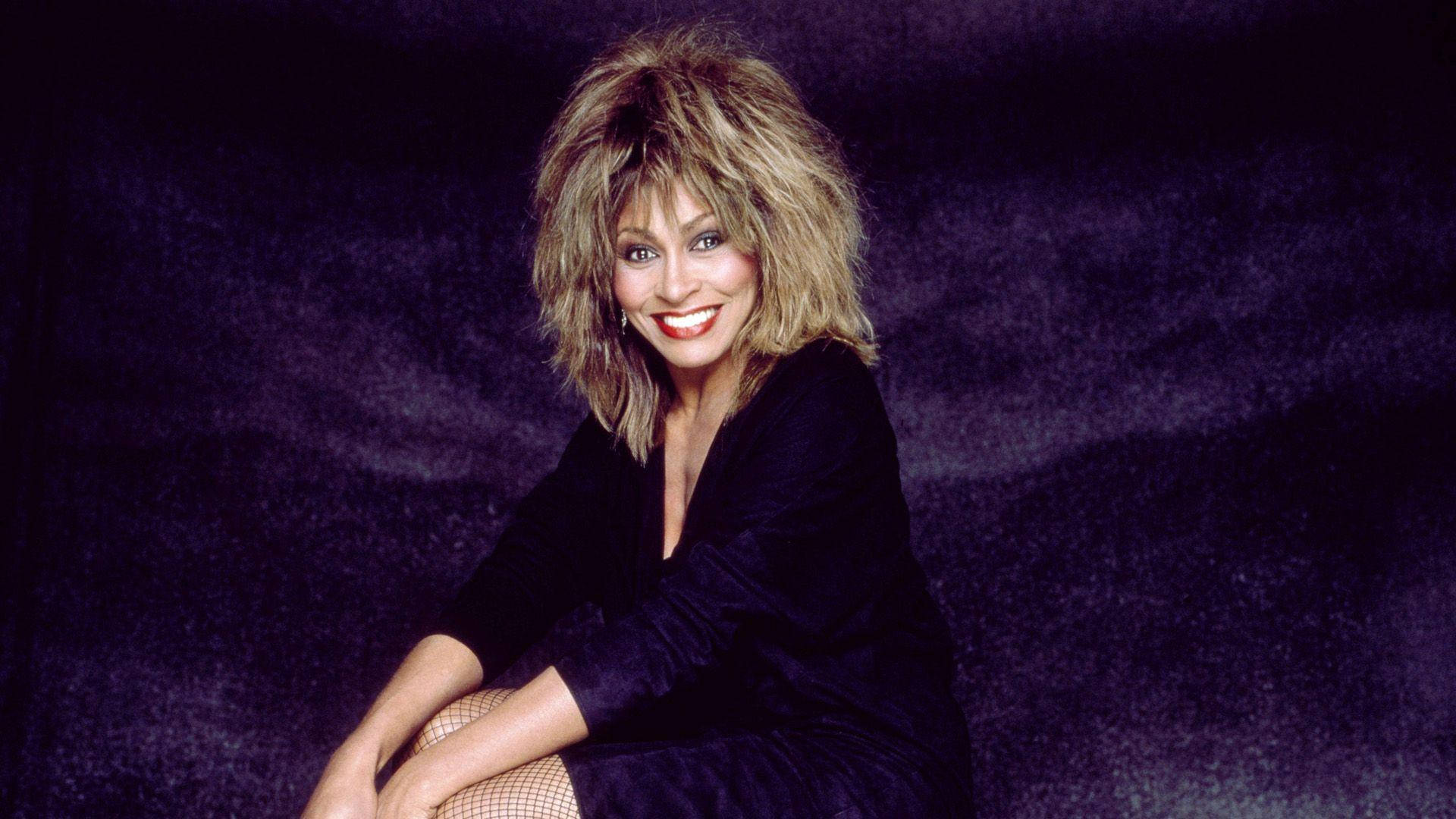 Tina Turner, voluminous blonde hair, deep purple textured backdrop, Full HD Desktop Wallpaper