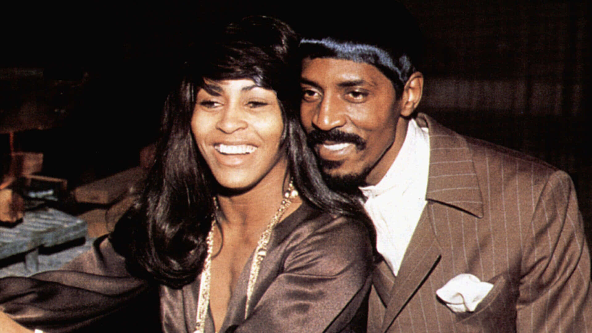 Ike And Tina Turner, 70s attire, dimly lit indoor setting, Full HD Desktop Wallpaper