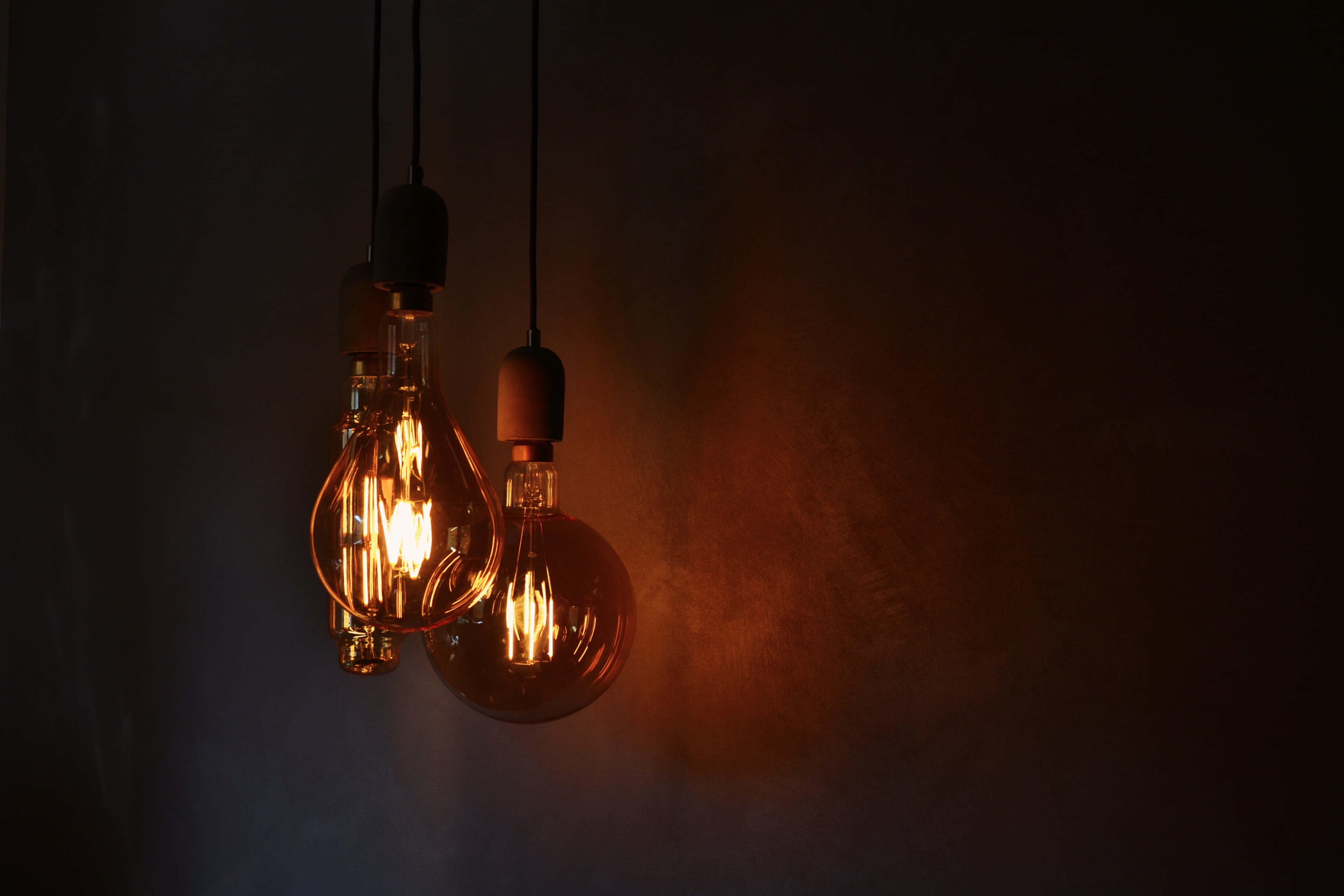 three incandescent bulbs, vintage filament bulbs, warm amber light, 4K Desktop Wallpaper