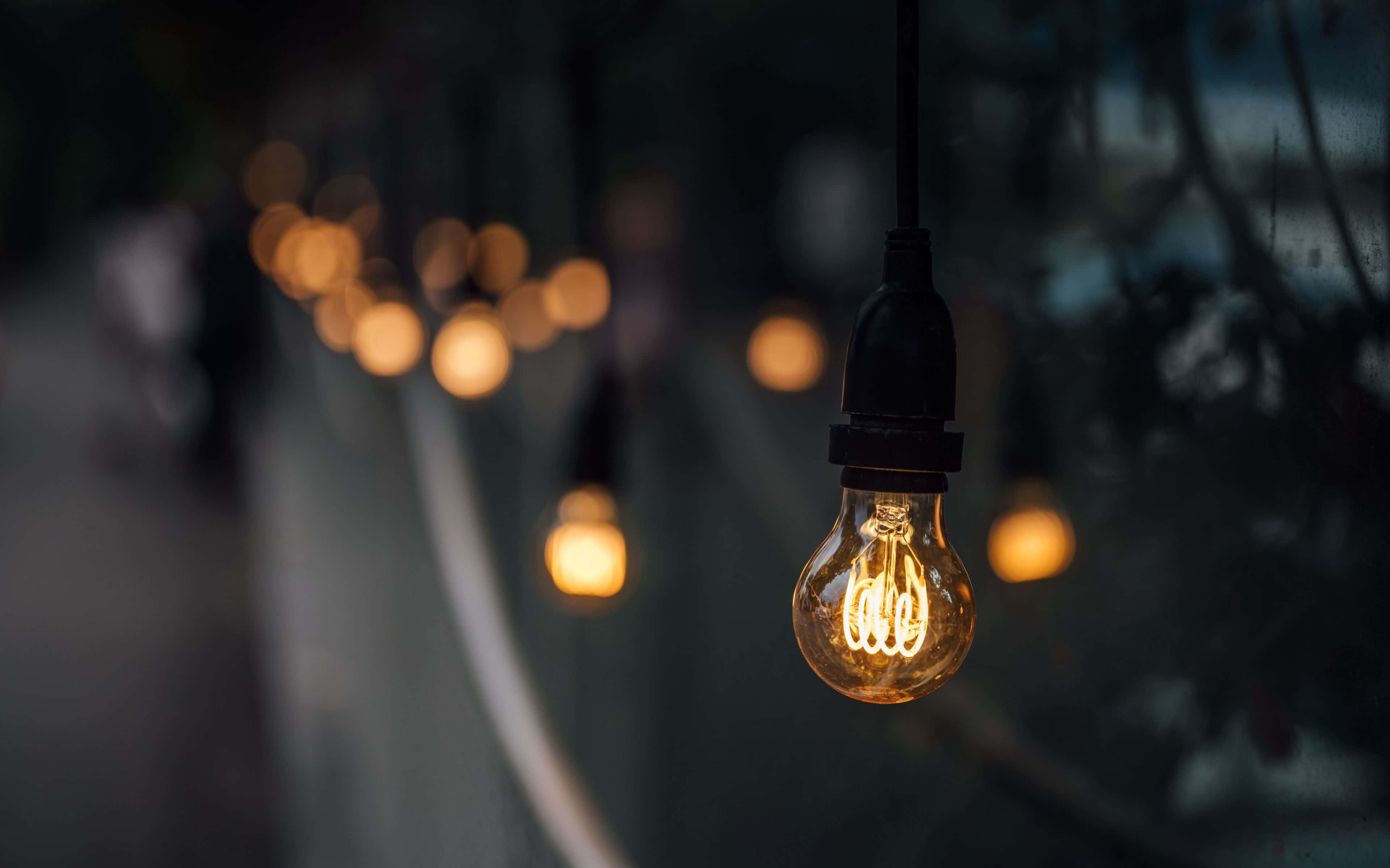 vintage filament bulb, warm bokeh lights, dark setting, 4K Desktop Wallpaper