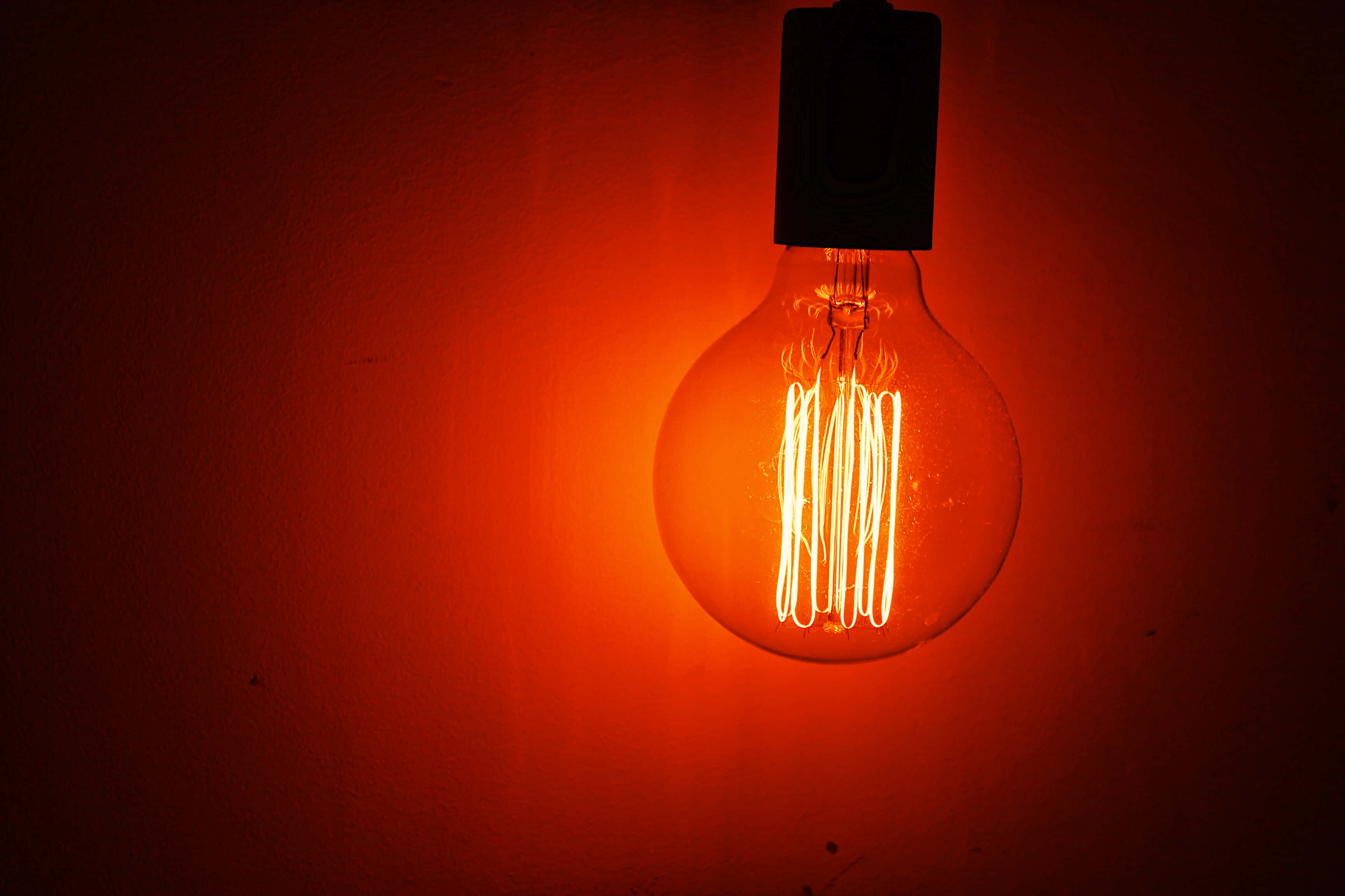 red orange incandescent bulb, vintage filament bulb, warm orange glow, 2K Desktop Wallpaper