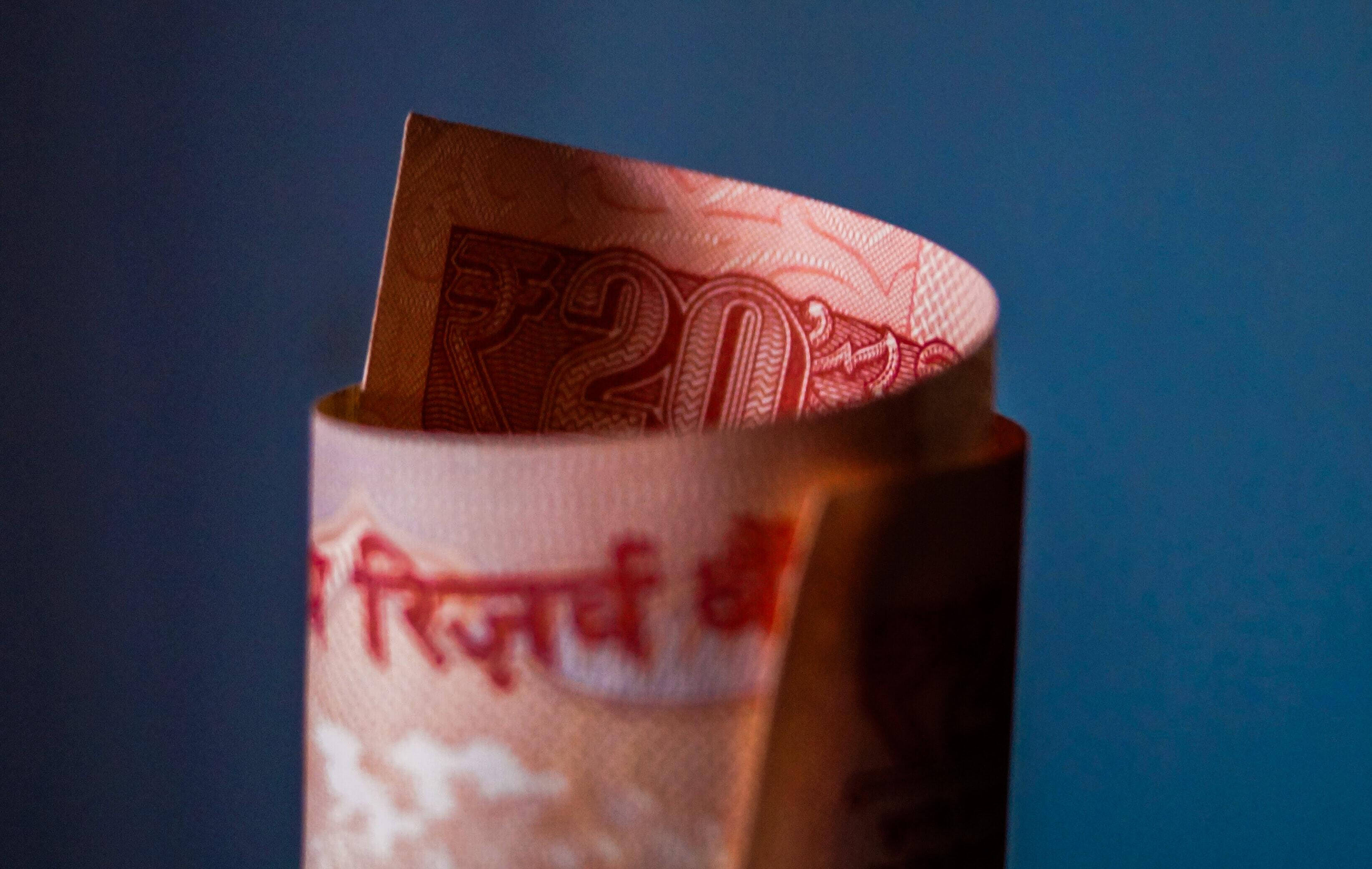 Indian Currency 20 Rolled Bill, twenty rupee Indian banknote, deep blue background, 2K Desktop Wallpaper