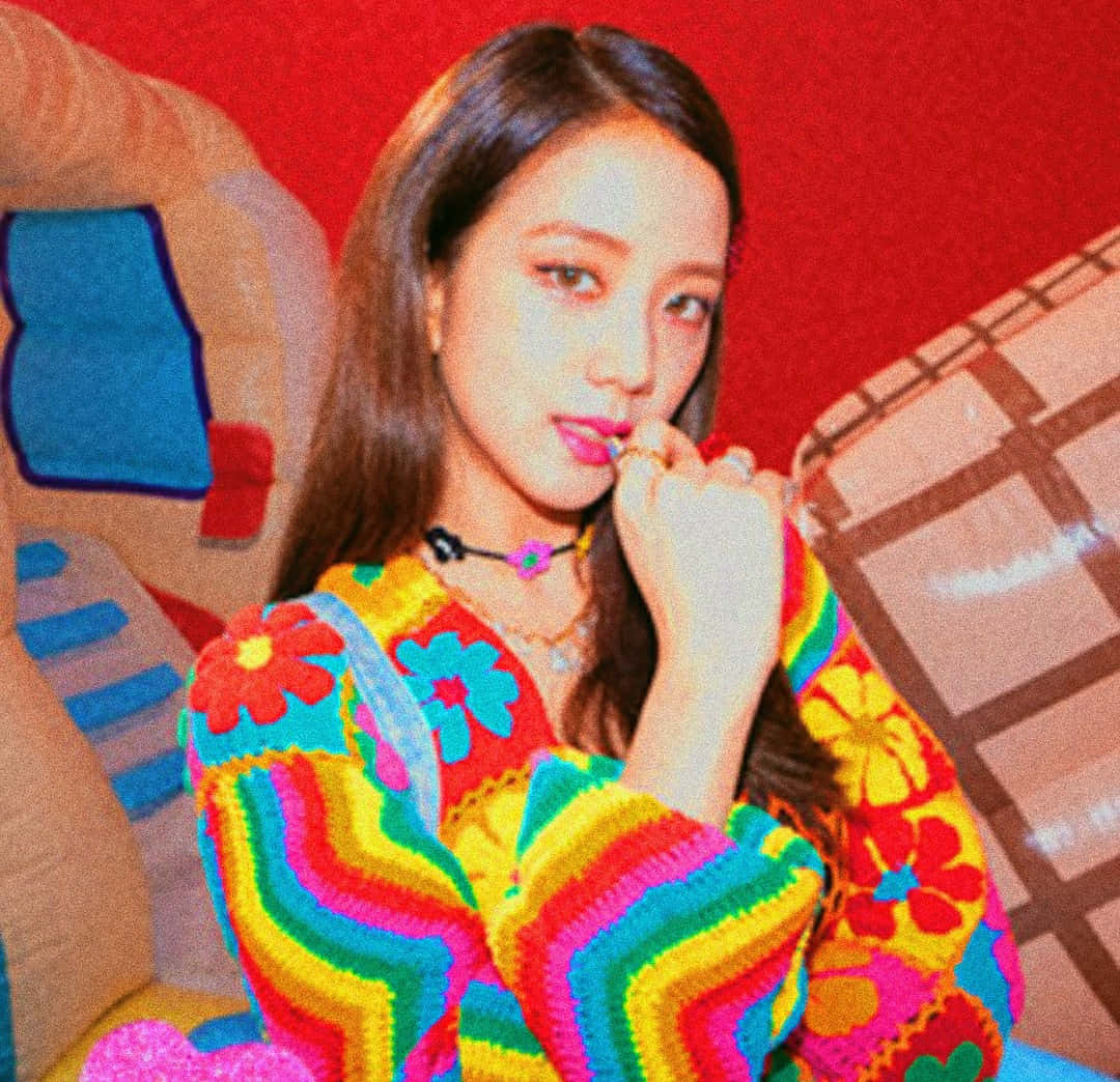 colorful indie style portrait, vibrant rainbow crochet sweater, bold red wall, SD Desktop Wallpaper