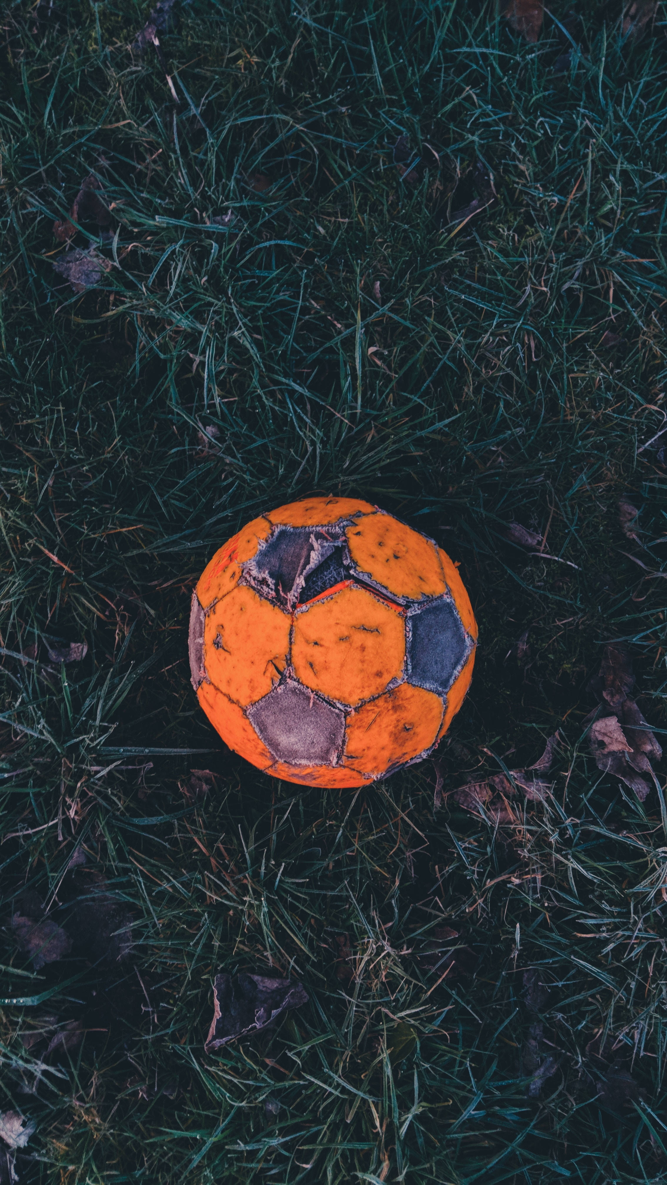 old soccer ball, orange soccer ball, dark green grass, 4K Phone Wallpaper