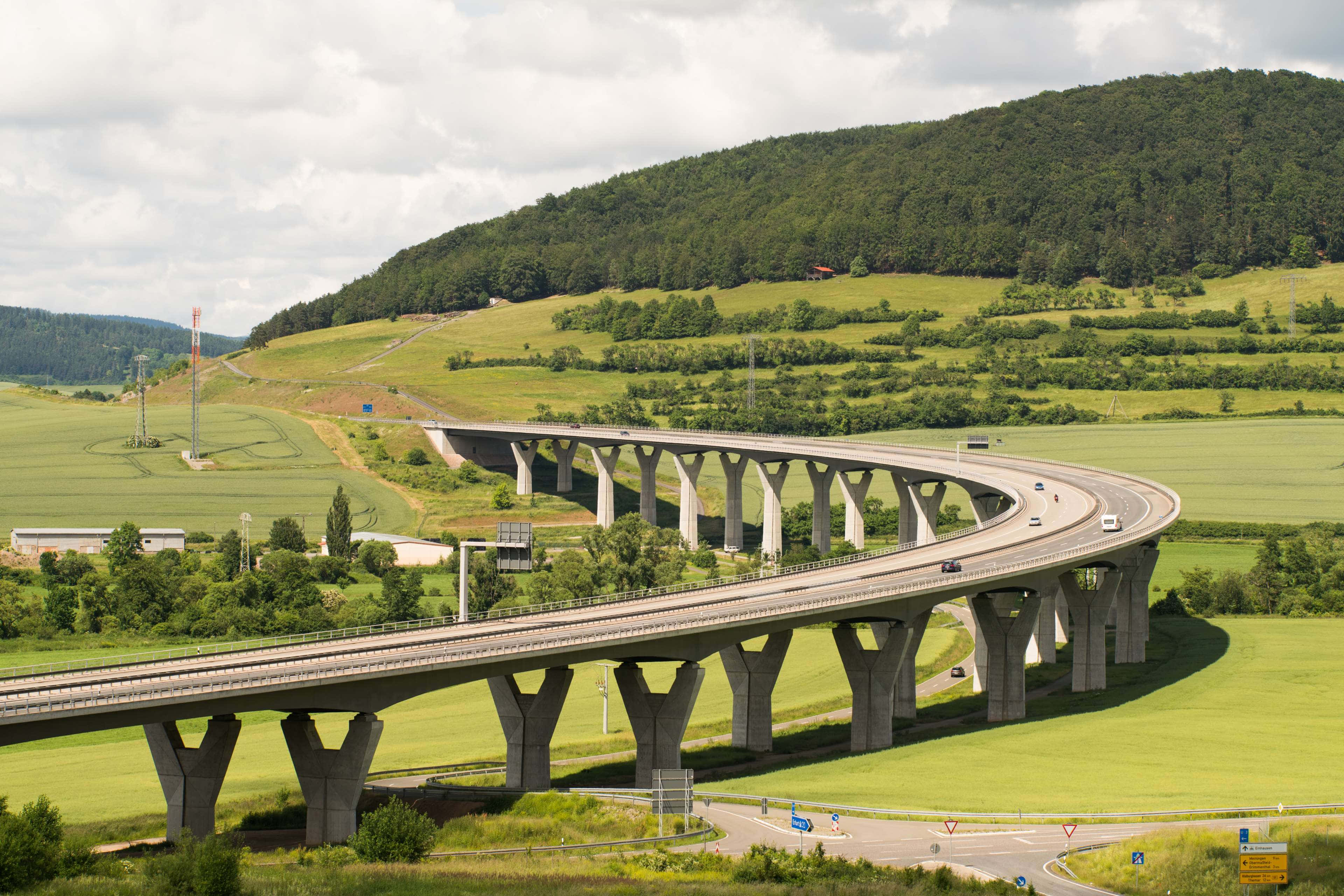 Modern Infrastructure, concrete highway bridge, lush green hills, 4K Desktop Wallpaper