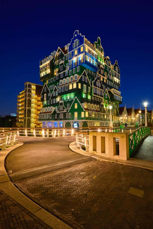Inntel Hotel Zaandam, green and blue illuminated building, traditional gabled architecture, SD Phone Wallpaper